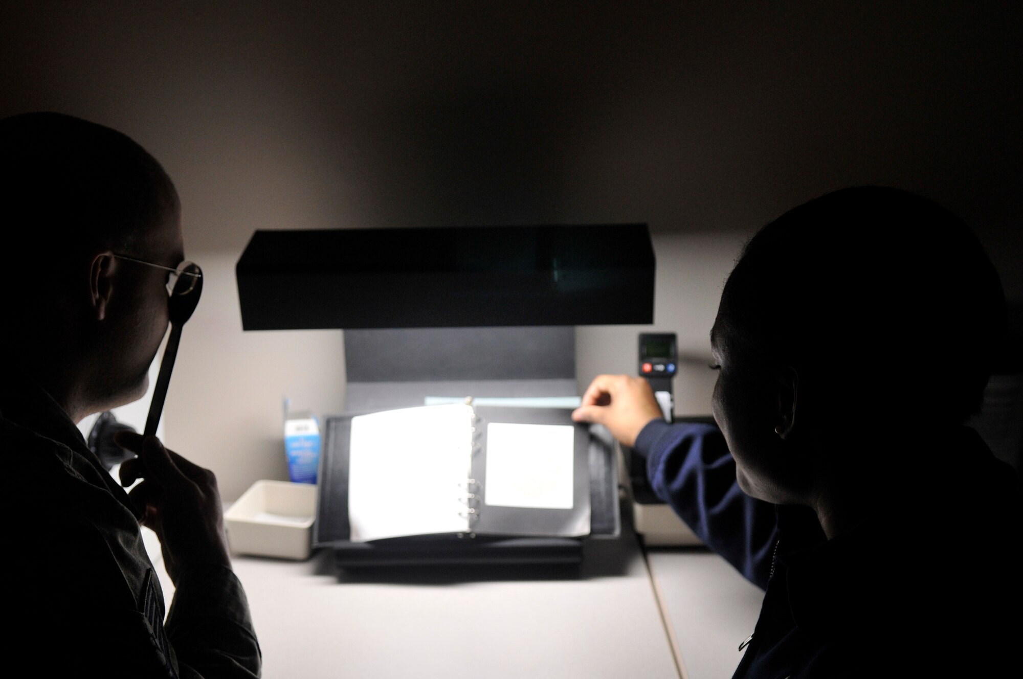 Airman Richelle Nico tests Tech Sgt. John G. Howard's color vision during a demonstration Jan. 1, 2010, Eielson Air Force Base, Alaska. Aerospace Flight Airmen care for pilots, emergency responders, their families and other selected groups. Sergeant Howard and Airman Nico are 354th Medical Group Aerospace Flight Airmen. (U.S. Air Force photo/Airman 1st Class Janine Thibault)