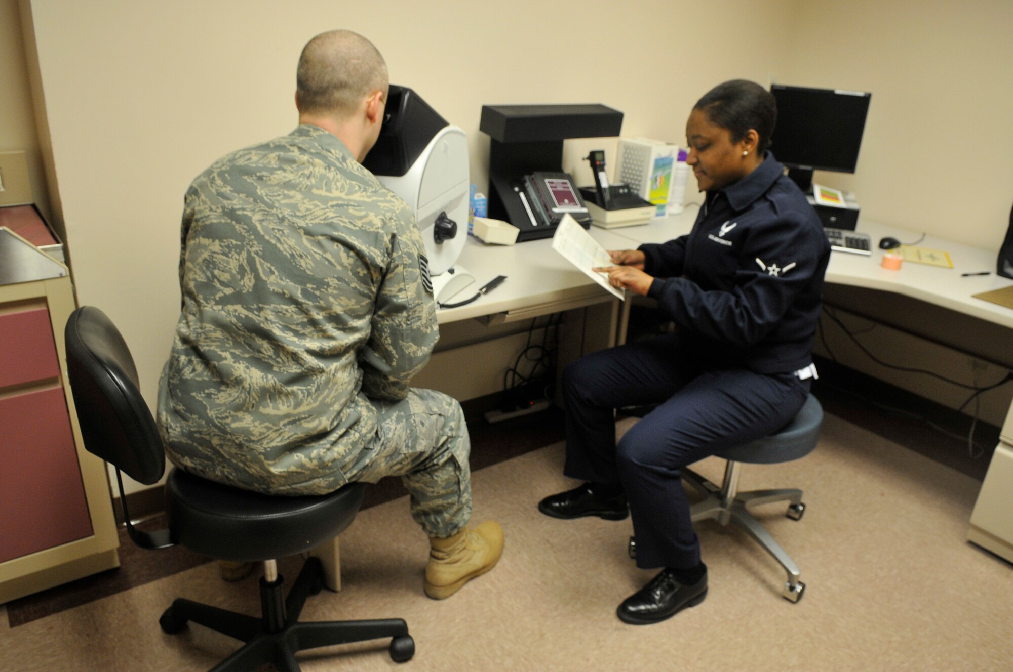 Airman Richelle Nico checks Tech. Sgt. John G. Howards answers during an eye exam demonstration Jan. 1, 2010, Eielson Air Force Base. The eye examination is one test Flight Medicine conducts on patients. Seargent Howard and Airman Nico are from the 354th Medical Group aerospace medicine flight. (U.S. Air Force photo/ Airman 1st Class Janine Thibault)