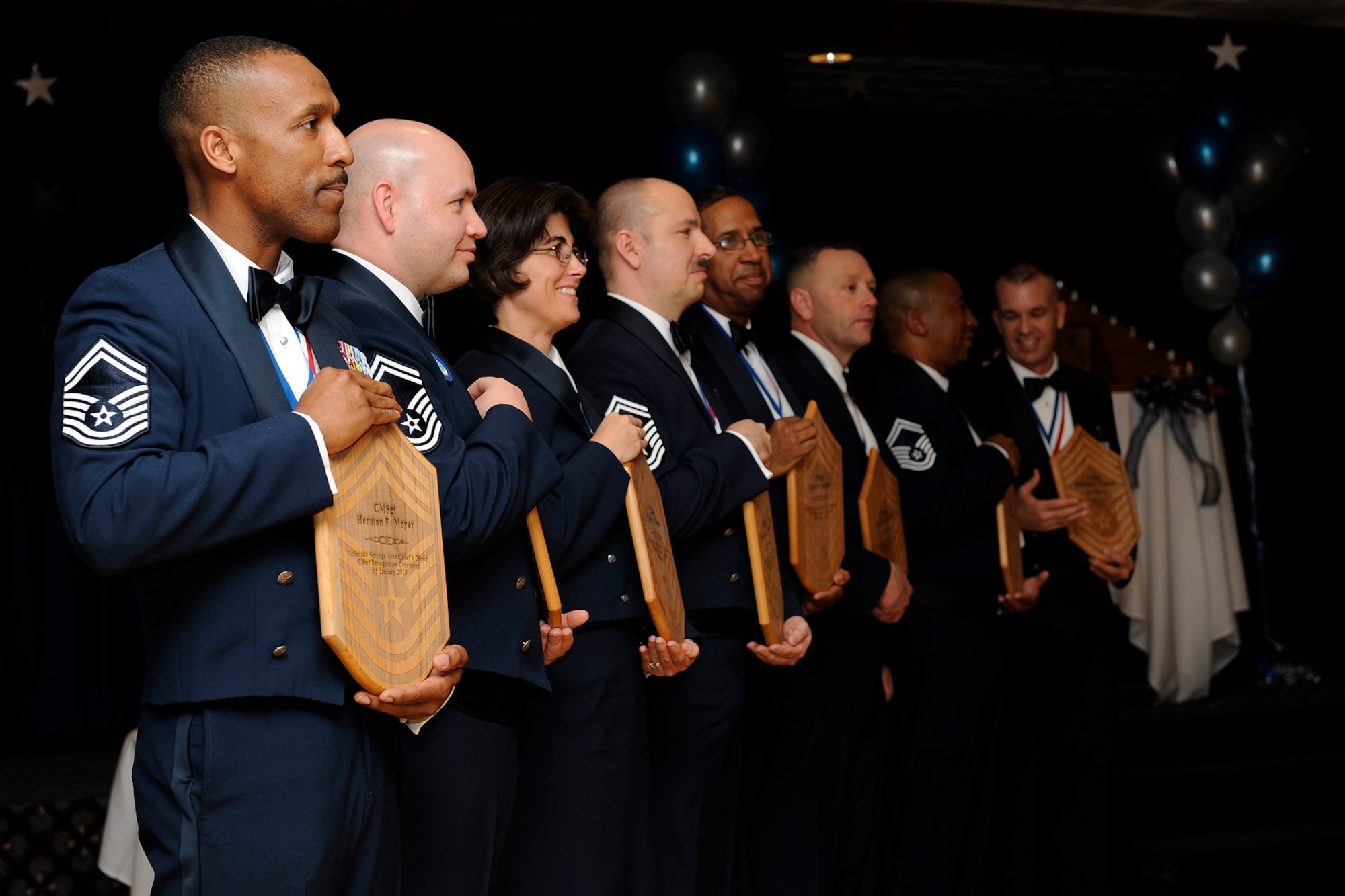 Some of Team Pete’s newest chief master sergeants display their plaques presented during the Jan. 15 chief recognition ceremony at The Club on Peterson Air Force Base. Chief Master Sgt. Robert Sealey, 21st Space Wing command chief, was the guest speaker at the ceremony and Maj. Gen. Michael Basla, Air Force Space Command vice commander, was on hand to celebrate the promotion of 16 new chief master sergeants. (Air Force photo by Craig Denton)