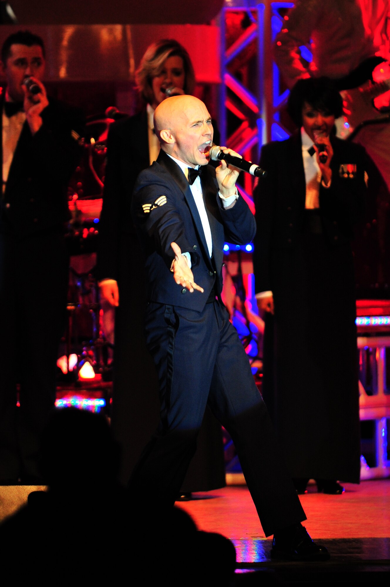 Senior Airman Jeffery Collins, Tops in Blue vocalist, performs "Proud to be an American" by Lee Greenwood during a performance at the Paramount Theater in downtown Goldsboro, N.C., Feb.1, 2010. Collins' primary job is an emergency management apprentice with the 87th Civil Engineer Squadron at McGuire Air Force Base, N.J. He hails from Somerset, Mo. (U.S. Air Force photo/Senior Airman Rae Perry)
