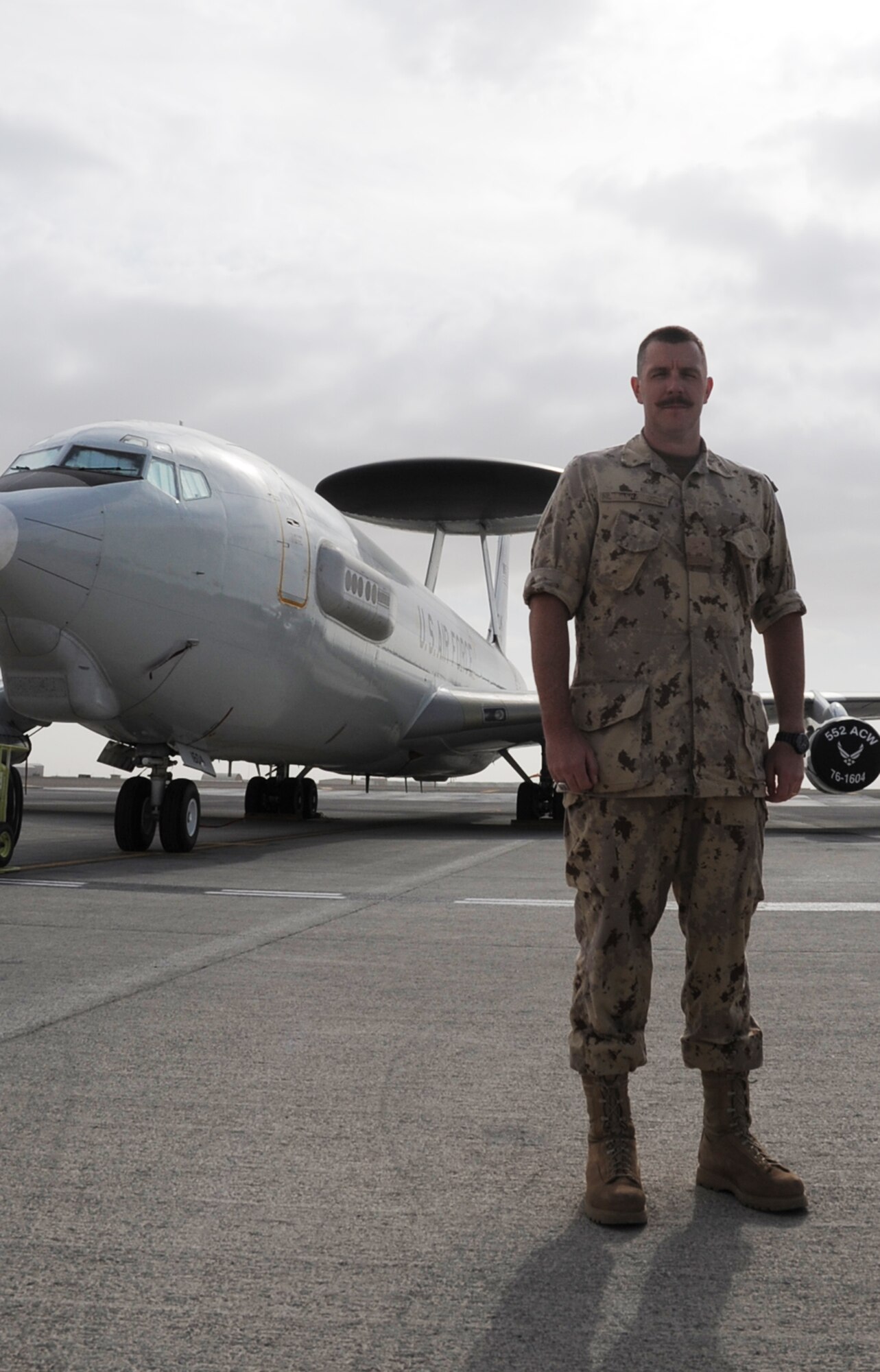 Canadian Forces Maj. Scott Marshall stands near an E-3 Sentry Airborne Warning and Control System aircraft at a non-disclosed base in Southwest Asia on Jan. 28, 2010.  Major Marshall is one of five Canadian Forces members deployed with the 965th Expeditionary Airborne Air Control Squadron.  The 13-year Canadian Forces veteran is a Mission Crew Commander for the E-3 Sentry.  The major is deployed from Tinker Air Force Base, Okla., and his hometown is Sudbury, Ontario, Canada.  (U.S. Air Force Photo/Master Sgt. Scott T. Sturkol/Released)