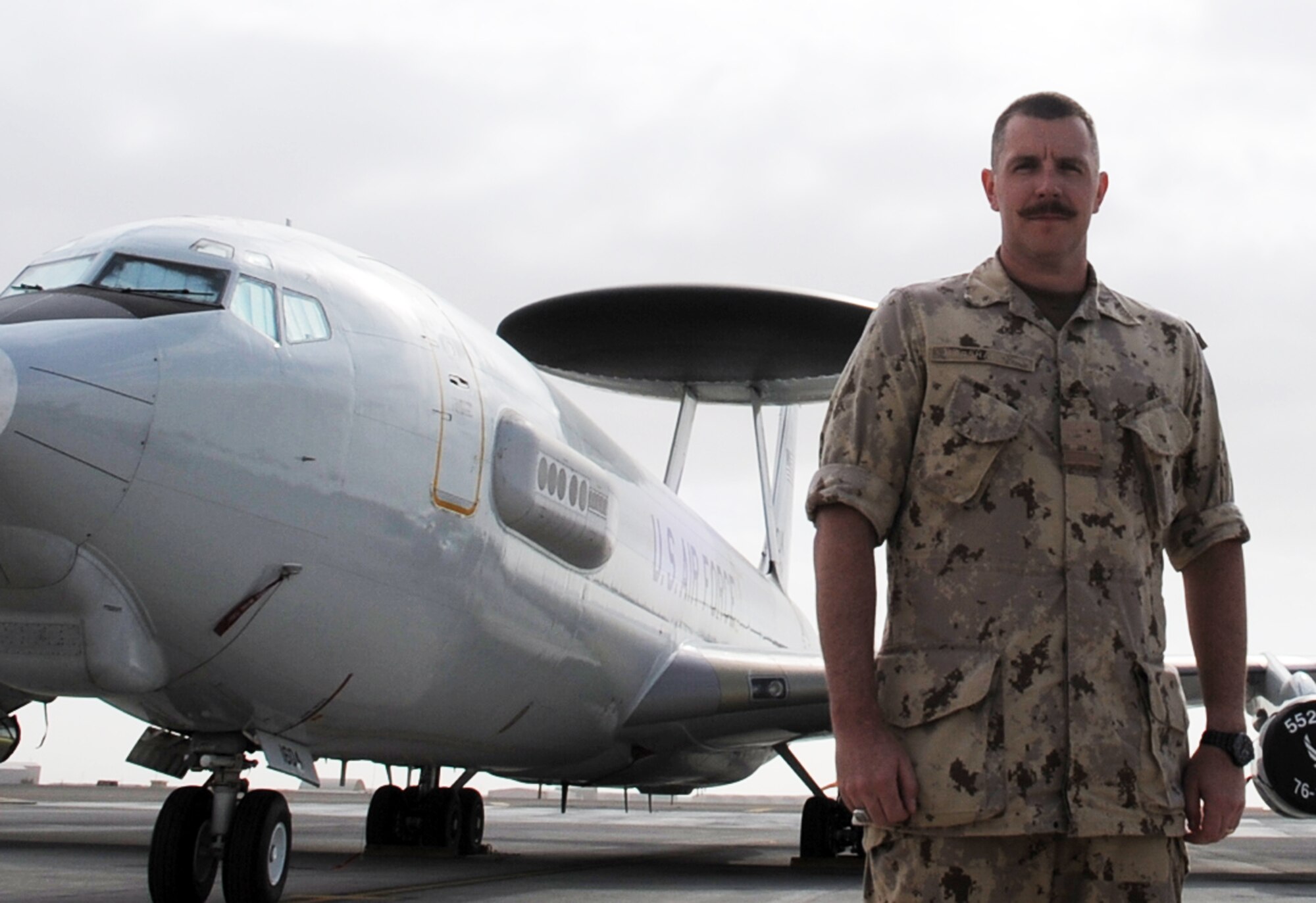 Canadian Forces Maj. Scott Marshall stands near an E-3 Sentry Airborne Warning and Control System aircraft at a non-disclosed base in Southwest Asia on Jan. 28, 2010.  Major Marshall is one of five Canadian Forces members deployed with the 965th Expeditionary Airborne Air Control Squadron.  The 13-year Canadian Forces veteran is a Mission Crew Commander for the E-3 Sentry.  The major is deployed from Tinker Air Force Base, Okla., and his hometown is Sudbury, Ontario, Canada.  (U.S. Air Force Photo/Master Sgt. Scott T. Sturkol/Released)