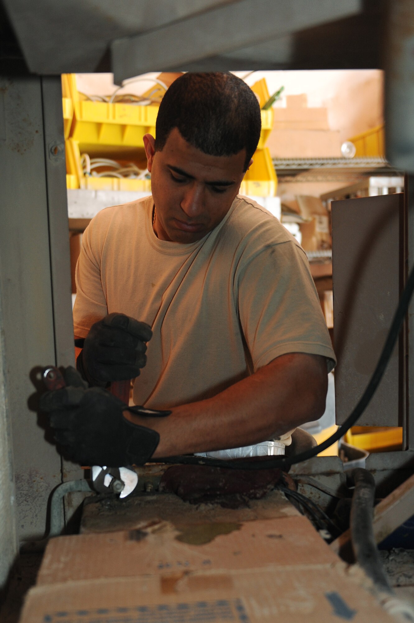 Staff Sgt. Braulio Jimenez, 379th Expeditionary Civil Engineer Squadron heating ventilation air-conditioning technician, replaces the safety port in an environment control unit at a non-disclosed Southwest Asia location, Feb. 03, 2010. (U.S. Air Force photo by Tech. Sgt. Michelle Larche)[RELEASED]