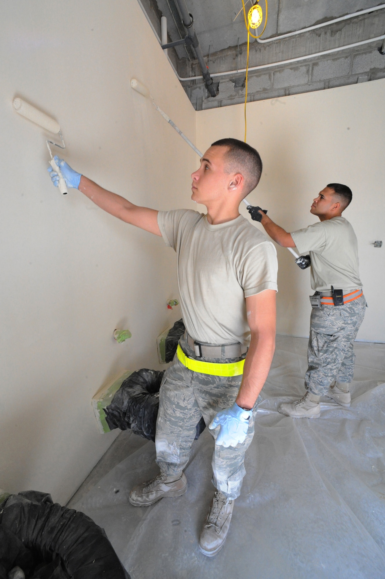 Airman Joel Hoffman (left) and Staff Sgt. Angel Diaz-Berrios, 379th Expeditionary Civil Engineer Squadron water and fuels systems maintenance, paint new bunker cadillac bathrooms at a non-disclosed Southwest Asia location, Feb. 01, 2010. (U.S. Air Force photo by Tech. Sgt. Michelle Larche)[RELEASED]