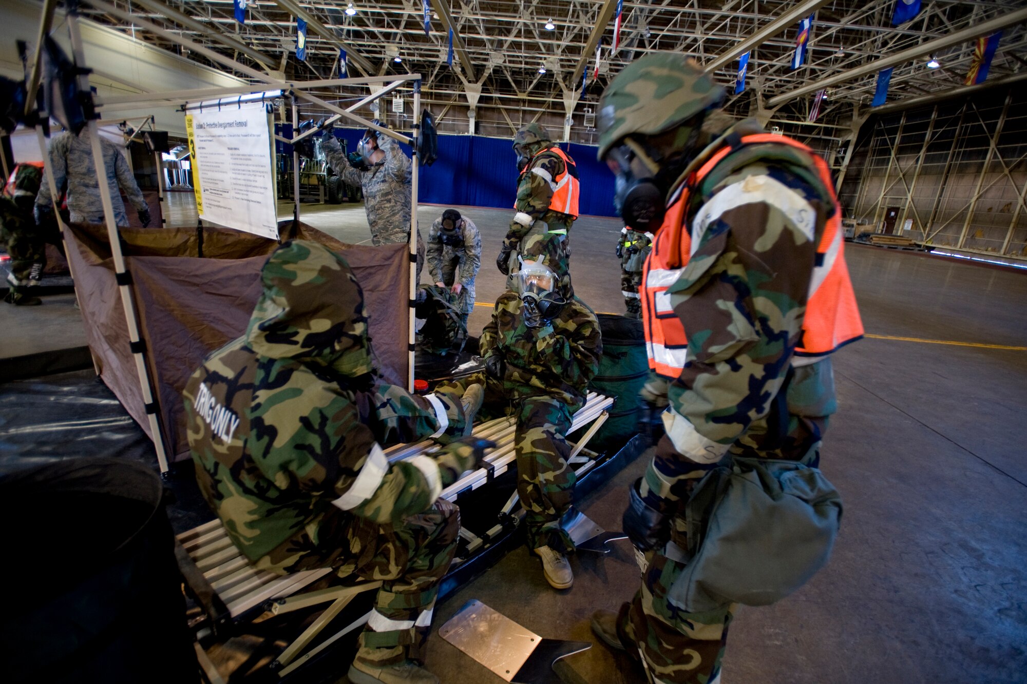 MISAWA AIR BASE, Japan -- Airmen remove each other's overboots Feb. 3 at a simulated contamination control area during an operational readiness exercise. Contamination control areas allow personnel to remove surface contamination and move to an area free of toxics. (U.S. Air Force photo/Senior Airman Jamal D. Sutter)