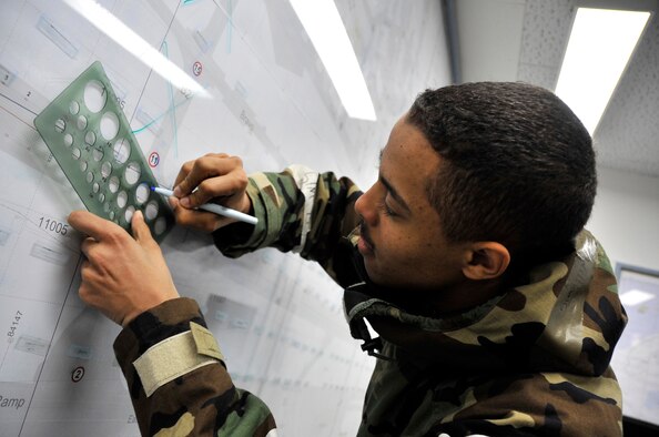 MISAWA AIR BASE, Japan -- Senior Airman Marquis Williams, engineering assistant, 35th Fighter Wing Command Post, marks the location of a simulated attack Feb. 3 during exercise Beverly Sunrise 10-01. The Emergency Operations Center provides incident response capabilities for the commander. (U.S. Air Force photo/Staff Sgt. Chad C. Strohmeyer)