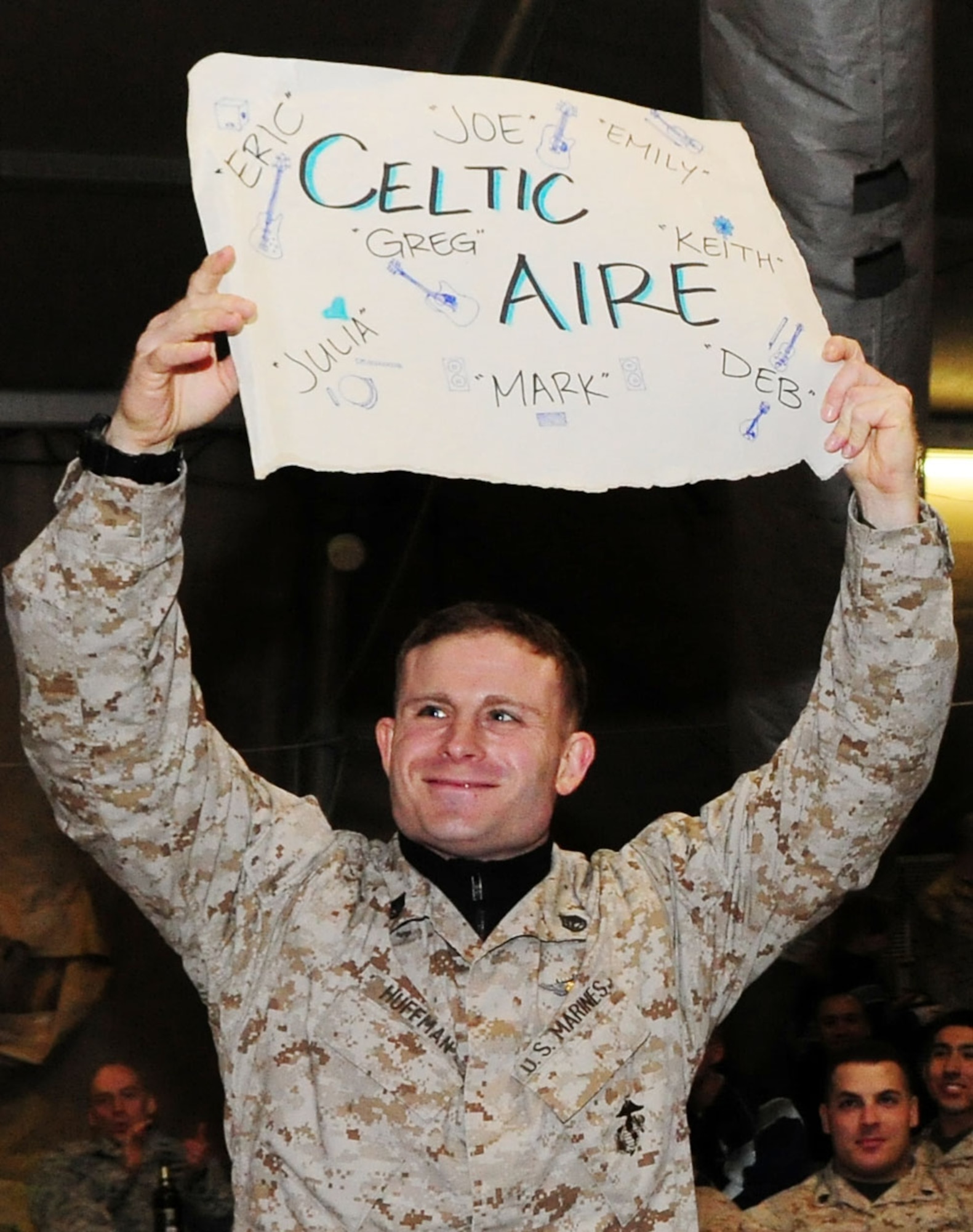 U.S. Marine Corps Staff Sgt. Ian Huffman shows his support for the U.S. Air Forces Central Public Affairs band "Celtic Aire" during a performs at the Transit Center at Manas, Kyrgyzstan, Jan. 31, 2010. Staff Sgt. Huffman is transiting through with fellow Marines from the Heavy Marine Helicopter Squadron 462, Marine Corps Air Station Mirmar, San Diego. (U.S. Air Force photo/Senior Airman Nichelle Anderson/Released)
