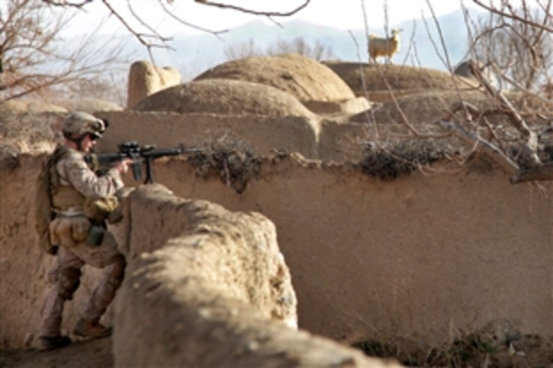 A U.S. Marine provides security for fellow Marines during a patrol through a town in Farah province, Afghanistan, Jan. 27, 2010. The Marines, assigned to India Company, 3rd Battalion, 4th Marine Regiment, are searching for Taliban forces as part of Operation Swift Change.