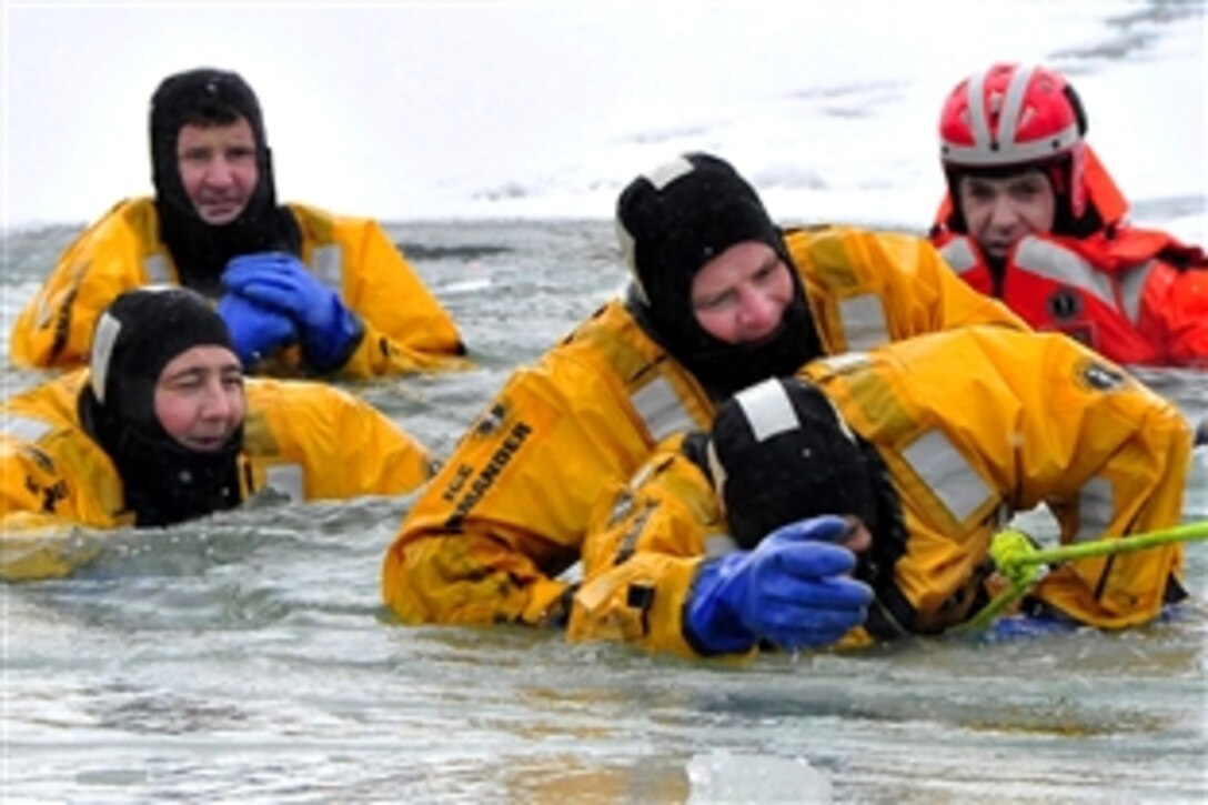 U.S. Coast Guard Petty Officer 2nd Class Tim Lieb provides self-rescue instructions to members of the Cleveland Fire Department during ice-rescue training in Cleveland Harbor, Ohio, Feb. 3, 2010. Station ice-rescue personnel conducted training with members of the Cleveland Fire Department in order to streamline joint-rescue efforts. Lieb is an ice rescue instructor from Coast Guard Station Cleveland Harbor.