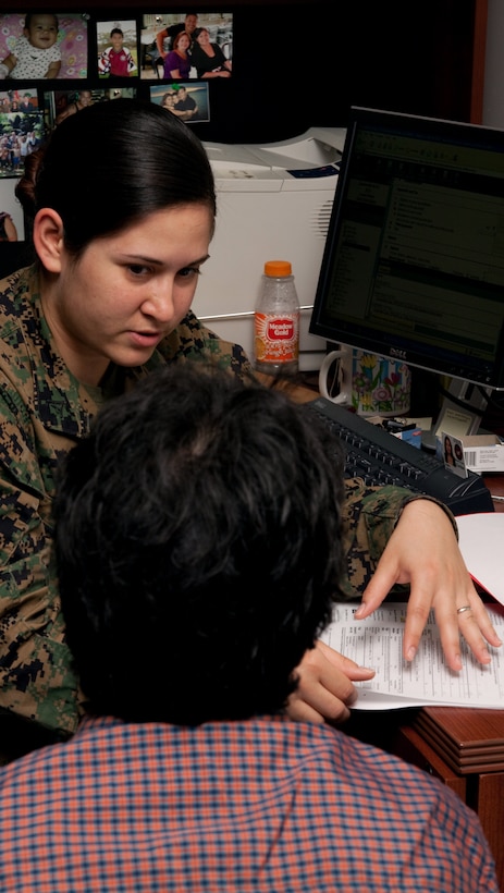 Lance Cpl. Lianny Wolf, legal clerk, explains the tax filing process to a customer Feb. 5 at the U.S. Marine Corps Forces, Pacific, Headquarters Building, Camp H. M. Smith, Hawaii. Personnel with the MarForPac Staff Judge Advocate's Office offer tax filing services Monday through Friday from 9 a.m. - 3 p.m.  (U.S. Marine Corps Photo by Sgt. Juan D. Alfonso) (Released)