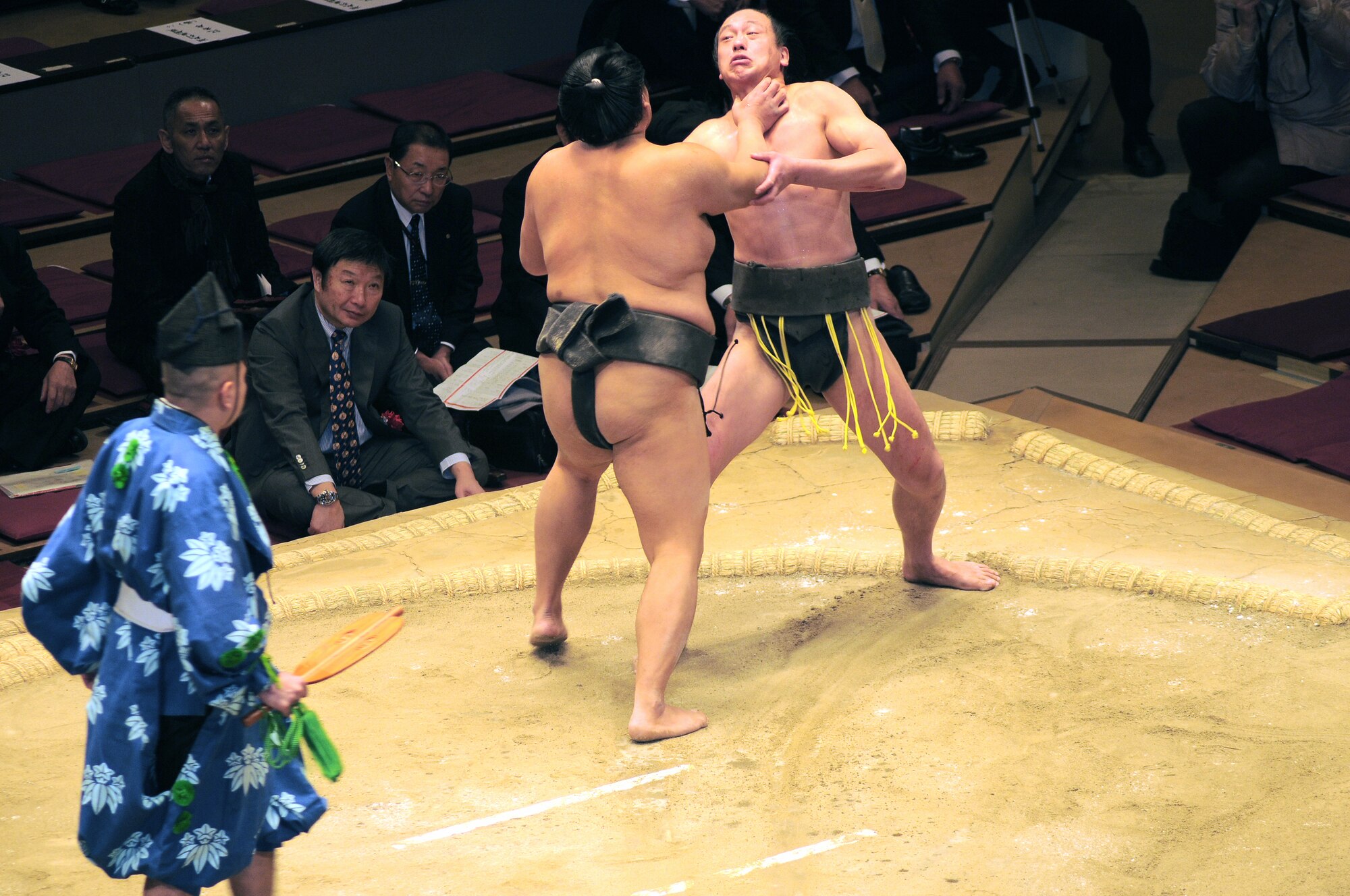 TOKYO -- In a bout of comedic display of proper sumo wrestling techniques one wrestler tries to choke another wrestler at the Royogoku Kokugikan "arena"  Jan. 31.  Amzumazwki-beya, a local Japanese sumo-training center, invited more than 600 students, parents and teachers from Yokota Air Base to experience this long held Japanese tradition. (U.S. Air Force photo/Airman 1st Class Katrina Menchaca)