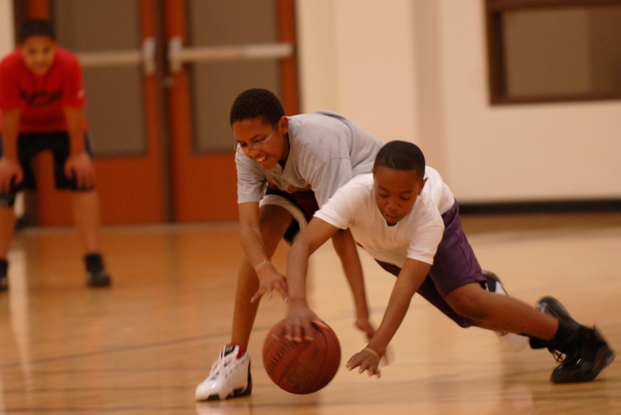 VANDENBERG AIR FORCE BASE, Calif. -- Deshawn Bowen fights to take the ball from Kyleek Fullwood during their practice the Vandenberg Fitness Center Monday, Feb. 1, 2010.  Vandenberg's senior boys basketball team, grades seven through eight, is preparing to enter a post-season tournament. (U.S. Air Force photo/Senior Airman Andrew Satran) 


 