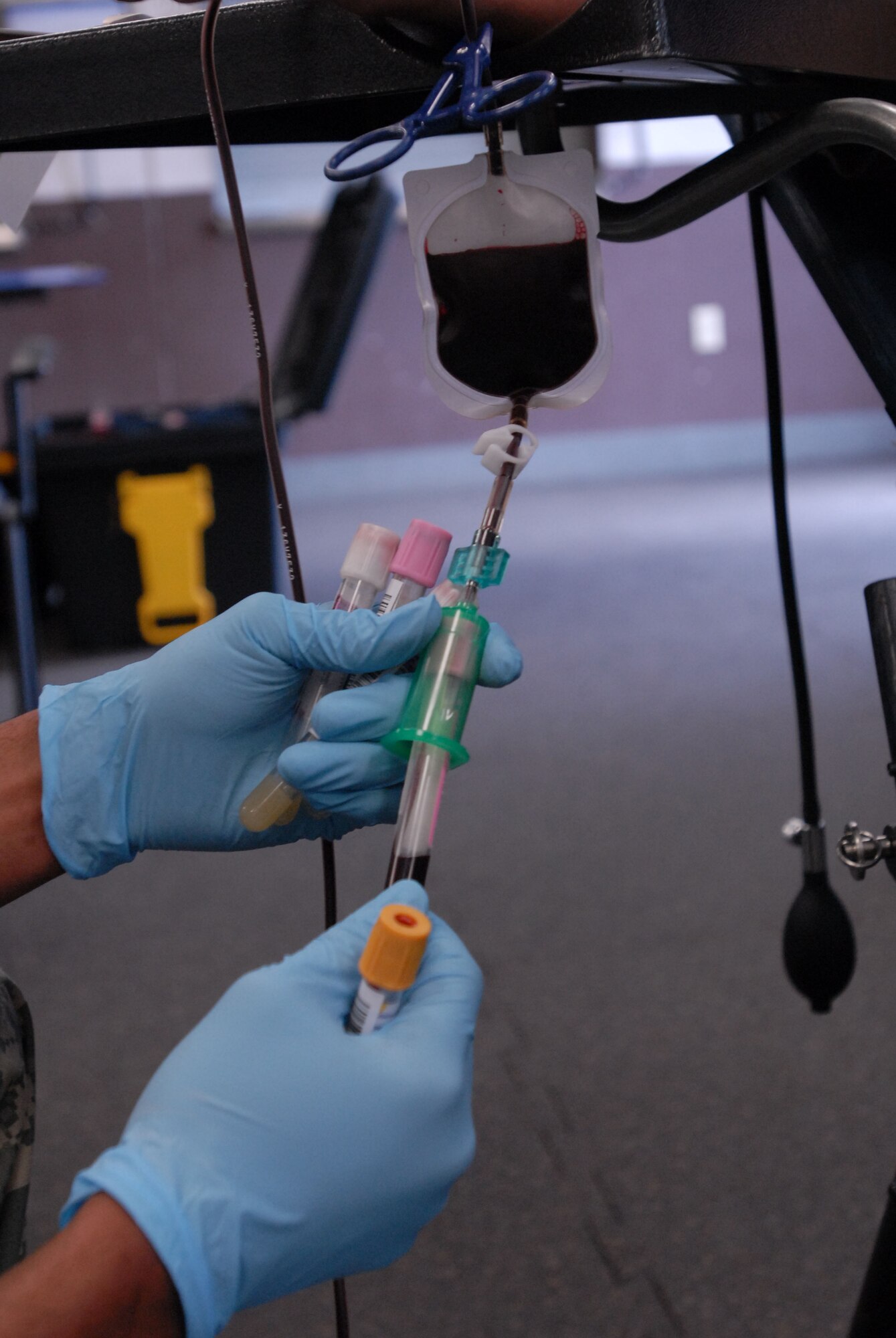 JOINT BASE PEARL HARBOR HICKAM, Hawaii - Specialist Christopher Goodman, Tripler Army Medical Center lab technician, retrieves blood during a blood donation here, Feb. 4. Blood donations made will be used for patients in Haiti, Iraq, and Afghanistan. TAMC projects 30-40 pints of blood for the day. (U.S. Air Force photo/Senior Airman Gustavo Gonzalez)