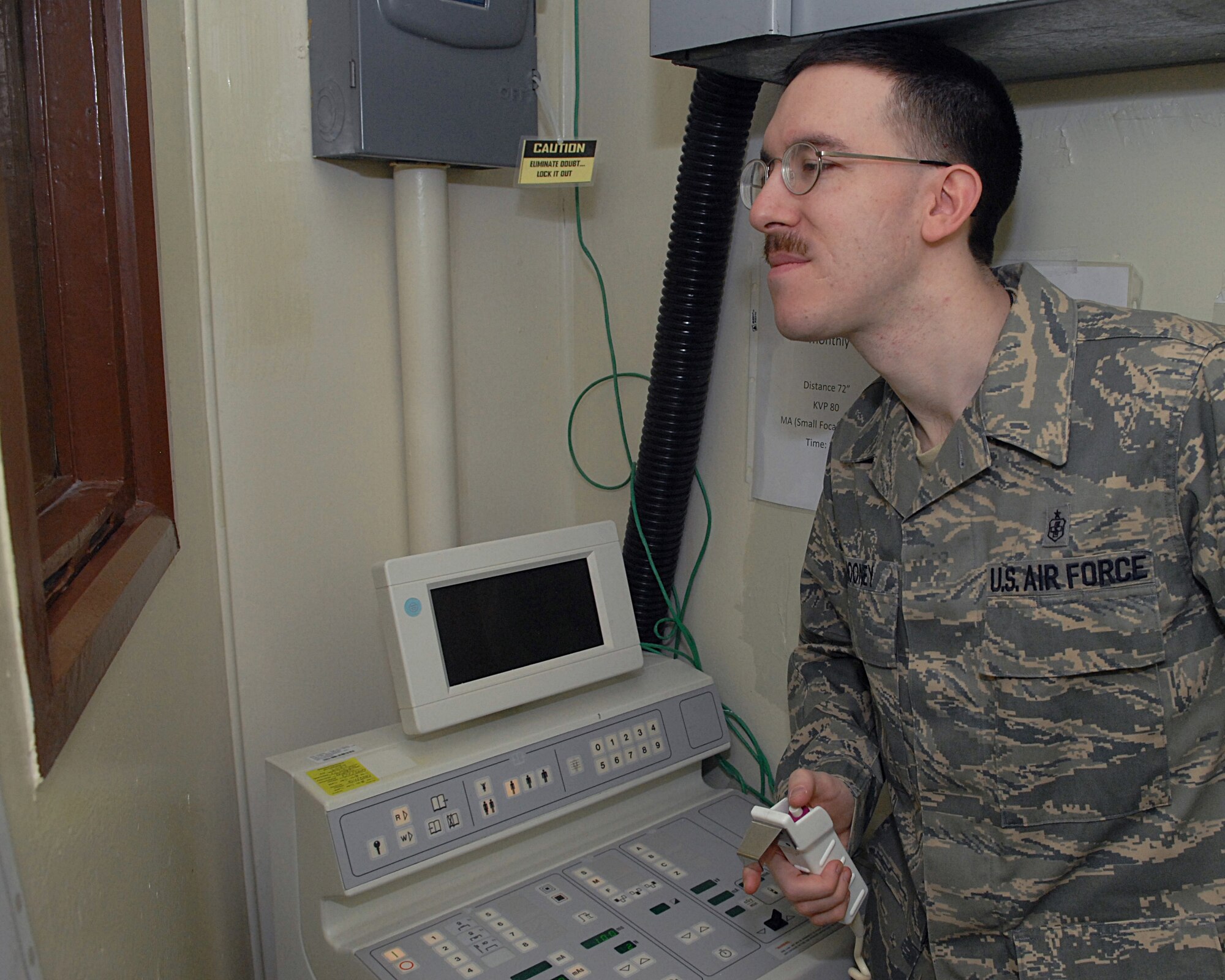 KUNSAN AIR BASE, Republic of Korea -- Staff Sgt. Joseph Mooney, 8th Medical Support Squadron diagnostic imaging technician, prepares to take an X-ray at the base clinic Feb. 4. Kunsan Diagnostic Imaging Technicians assist radiologist and physicians by producing diagnostic medical images. (U.S. Air Force photo/Senior Airman Roy Lynch)