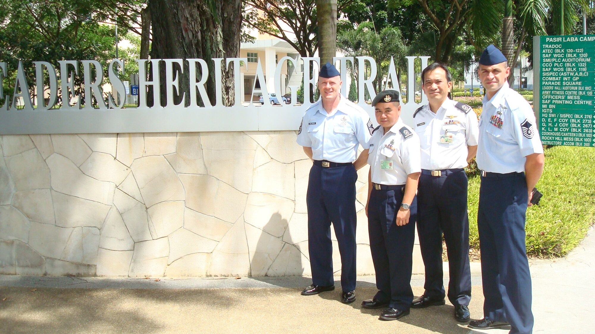 (Far left) 13th Air Force Command Chief Master Sgt. Dave Williamson, (inside left) Singapore Air Force Master Warrant Officer Ricky Woo, (inside right) Master Warrant Officer Joseph Pereira, (far right) U.S. Air Force Master Sgt. Nathan Prince pose in front of the Leader Heritage Trail at Pasir Laba Camp, Singapore Jan. 29 prior to the Singapore Armed Forces Warrant Officer School's Advanced Leadership Programme graduation. Sergeant Prince is the first Hickam-based non-commissioned officer to attend the school.  (Courtesy photo)
