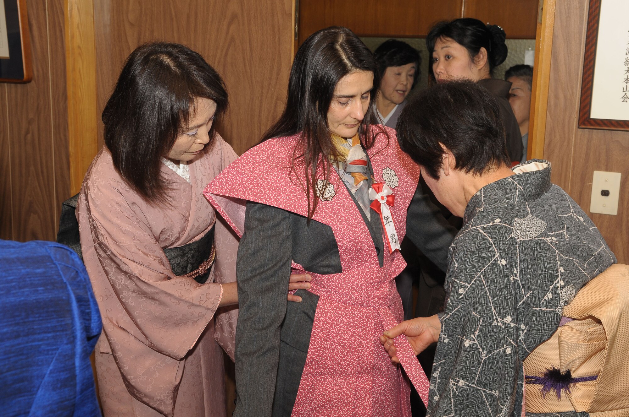 HINO, Japan -- Eva Romero, wife of Col. Rafael Quezada, 374th Mission Support Group commander, puts on a "Kamishimo," a formal piece of clothing worn by a samurai or a Japanese warrior, during the bean throwing ceremony at Takahat Fudo Temple Feb. 3. During the ceremony, people throw roasted soybeans while shouting "Fu ku wa uchi" which means, "Come in happiness". It is believed that if you eat the number of beans equal to your age, you will have a happy and healthy life. (U.S. Air Force photo/Airman 1st Class Sean Martin)
