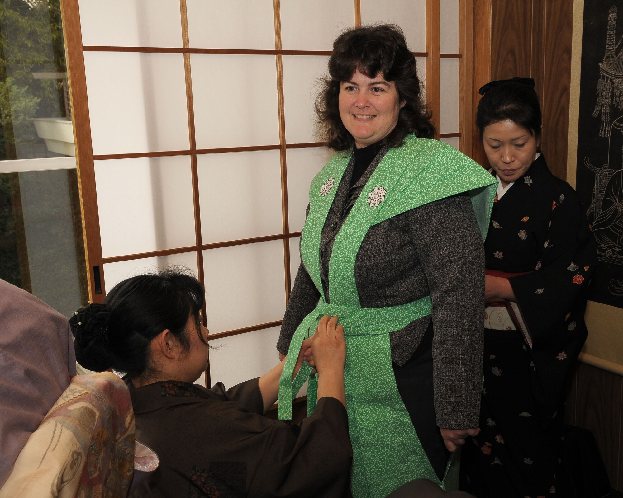 HINO, Japan -- Jennifer Hamuka, wife of Col. John Hamuka, 515th Air Mobility Operations Group deputy commander, puts on a "Kamishimo," a formal piece of clothing worn by a samurai or a Japanese warrior, during the bean throwing ceremony at Takahata Fudo Temple Feb. 3. During the ceremony, people throw roasted soybeans while shouting "Fu ku wa uchi," which means, "Come in happiness". It is believed that if you eat the number of beans equal to yur age, you will have a happy and healthy life. (U.S. Air Force photo/Airman 1st Class Sean Martin)
