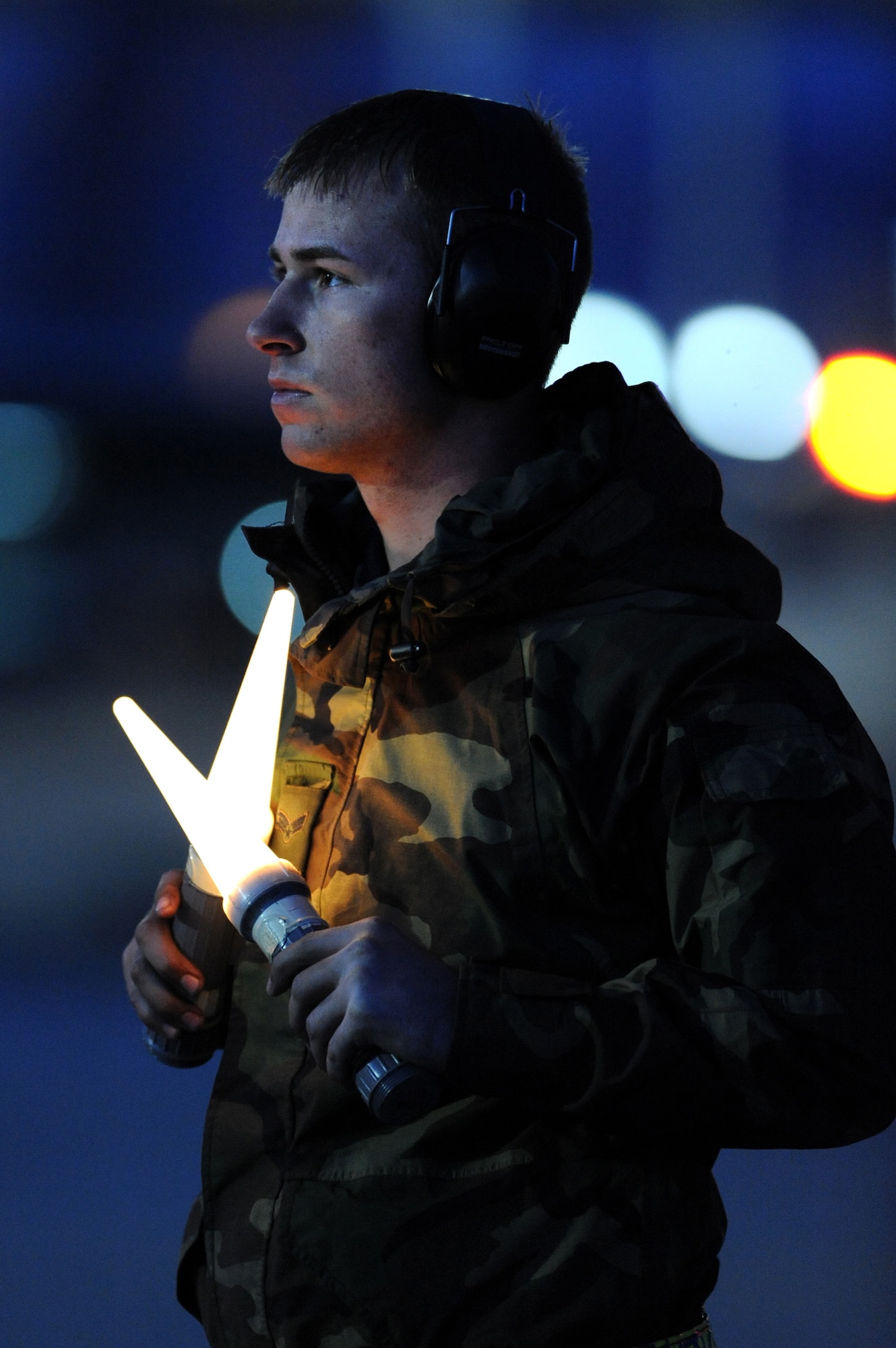 NELLIS AIR FORCE BASE, Nev. -- Senior Airman Patrick Naler, 18th Aircraft Maintenance Squadron, Kadena Air Base, Japan, uses flash lights to communicate to the pilot to hold before launching his F-15 Eagle on a night training mission at Red Flag 10-2, Feb. 2, 2010.  Red Flag is a realistic combat training exercise involving the air forces of the United States and its allies. The exercise is conducted on the 15,000-square-mile Nevada Test and Training Range, north of Las Vegas. (U.S. Air Force photo by Tech. Sgt. Michael R. Holzworth/RELEASED)



