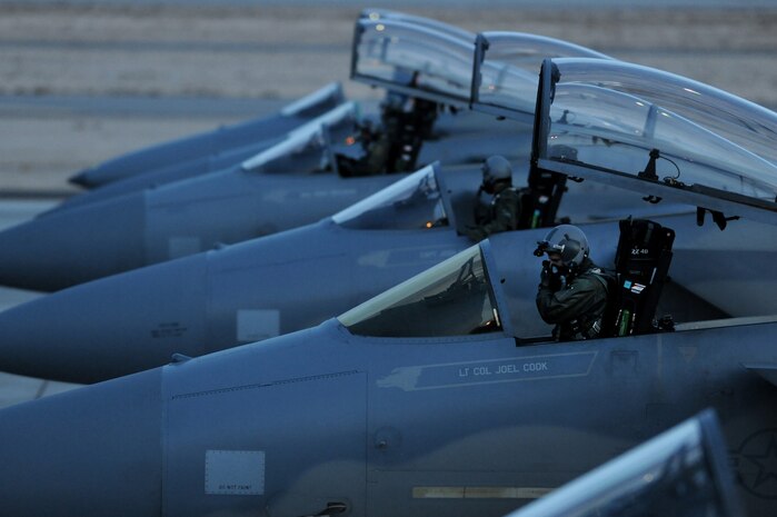 NELLIS AIR FORCE BASE, Nev. -- F-15 Eagle pilots from the 44th Fighter Squadron Kadena Air Base, Japan put on their helmets and go through their pre-flight checks before departing on a night training mission at Red Flag 10-2, Feb. 2, 2010.  Red Flag is a realistic combat training exercise involving the air forces of the United States and its allies. The exercise is conducted on the 15,000-square-mile Nevada Test and Training Range, north of Las Vegas. (U.S. Air Force photo by Tech. Sgt. Michael R. Holzworth/RELEASED)