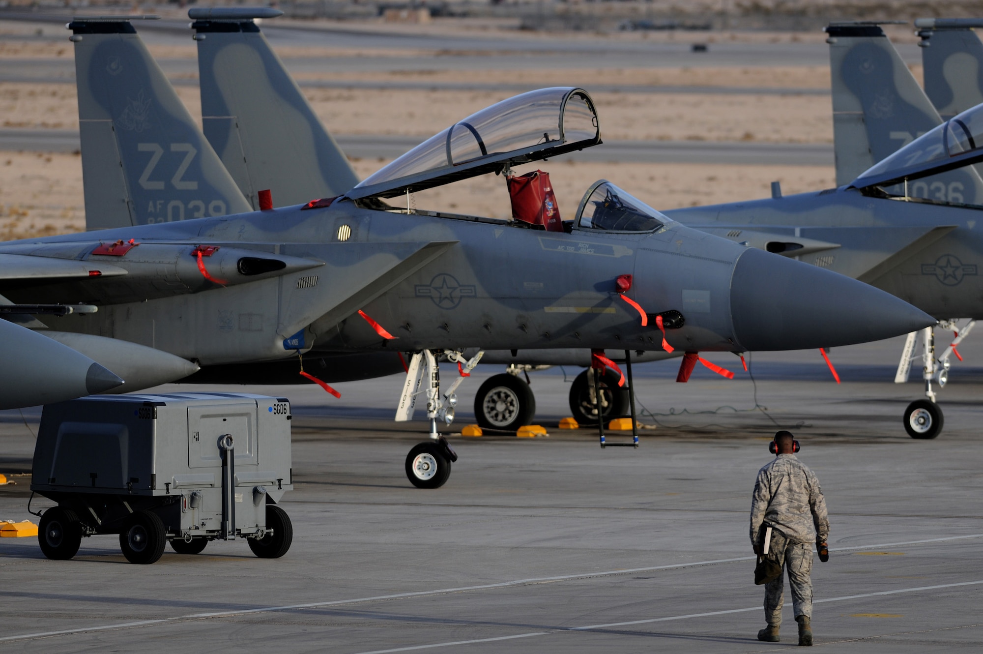 NELLIS AIR FORCE BASE, Nev. -- A crew chief assigned the 18th Aircraft Maintenance Squadron, walks toward a row 44th Fighter Squadron F-15's to perform pre-flight inspections at Red Flag 10-2  Feb. 2, 2010.  Red Flag is a realistic combat training exercise involving the air forces of the United States and its allies. The exercise is conducted on the 15,000-square-mile Nevada Test and Training Range, north of Las Vegas. (U.S. Air Force photo by Tech. Sgt. Michael R. Holzworth/RELEASED)
