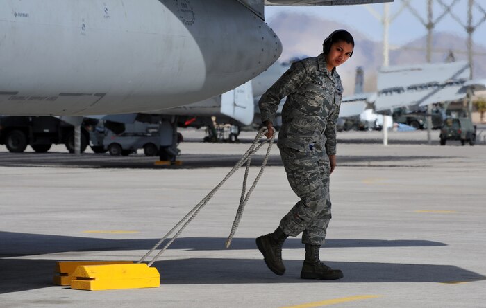 NELLIS AIR FORCE BASE, Nev. -- Senior Airman Rebecca Aguilar, 18th Aircraft Maintenance Squadron, Kadena Air Base, Japan, pulls the chalks from an F-15 Eagle before it is launched on a training mission at Red Flag 10-2, Nellis Air Force Base, Nev., Feb. 2, 2010.  Red Flag is a realistic combat training exercise involving the air forces of the United States and its allies. The exercise is conducted on the 15,000-square-mile Nevada Test and Training Range, north of Las Vegas. (U.S. Air Force photo by Tech. Sgt. Michael R. Holzworth/RELEASED)