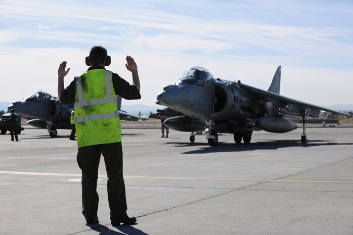 NELLIS AIR FORCE BASE, Nev. -- A crew chief  assigned to Royal Air Force Cottesmore, United Kingdom, marshals a GR-9 Harrier on the Nellis flight line during Red Flag 10-2   Feb. 1, 2010.  Red Flag is a realistic combat training exercise involving the air forces of the United States and its allies. The exercise is conducted on the 15,000-square-mile Nevada Test and Training Range, north of Las Vegas. (U.S. Air Force photo by Tech. Sgt. Michael R. Holzworth/RELEASED)