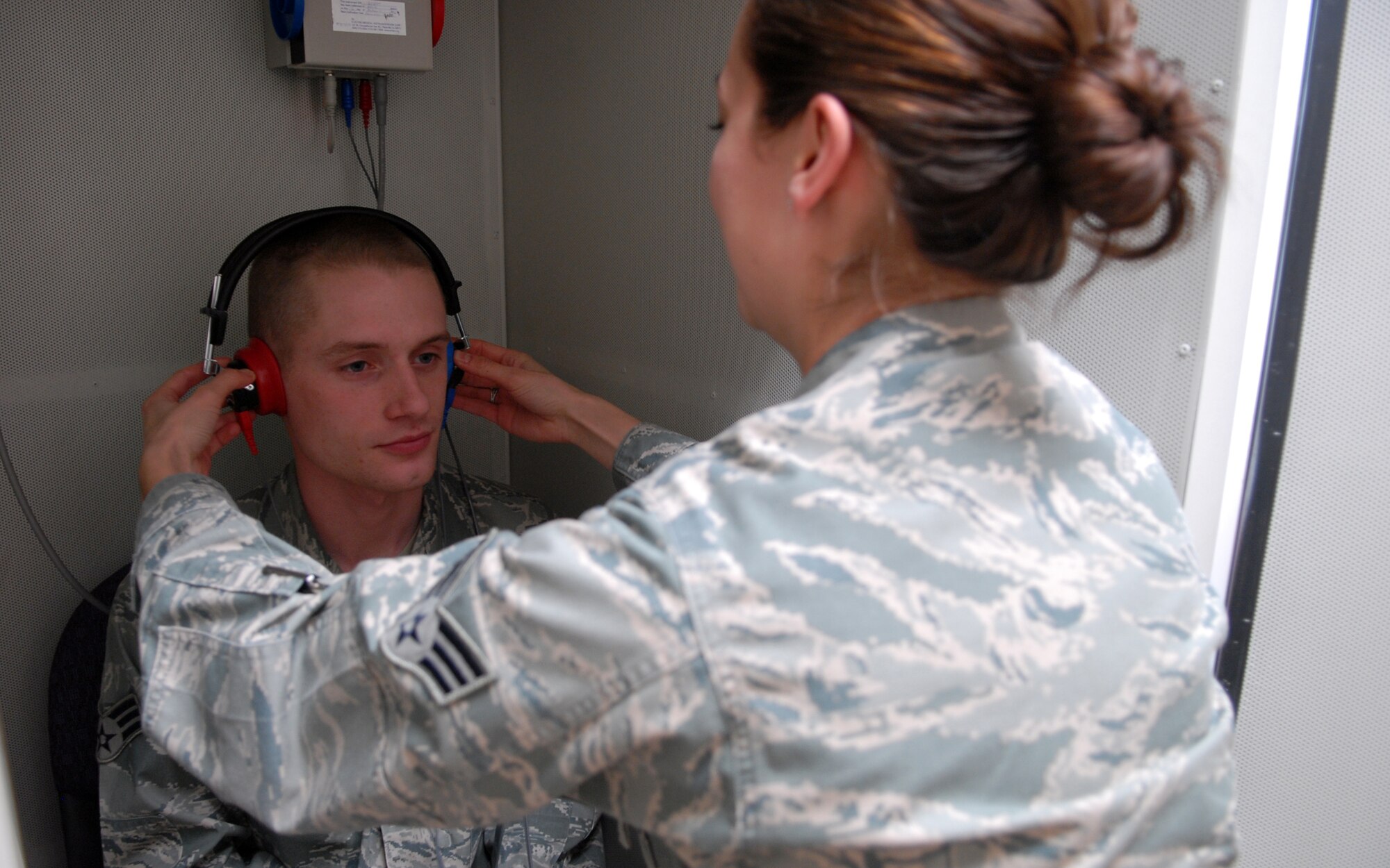 VANDENBERG AIR FORCE BASE, Calif. -- Ensuring a tight fit on both ears, Senior Airman Caitlin Gaudet fits Senior Airman Christopher Salzsieder with a head set for a hearing test here Tuesday, Feb. 2, 2010. The secure fitting is usually preceded with a lighted ear exam to make sure the patient’s ears are free of obstruction so that the test may be administered without fail. Both Airmen are with the 30th Medical Operations Squadron Public Health office. (U.S. Air Force photo/Airman 1st Class Angelina Drake)