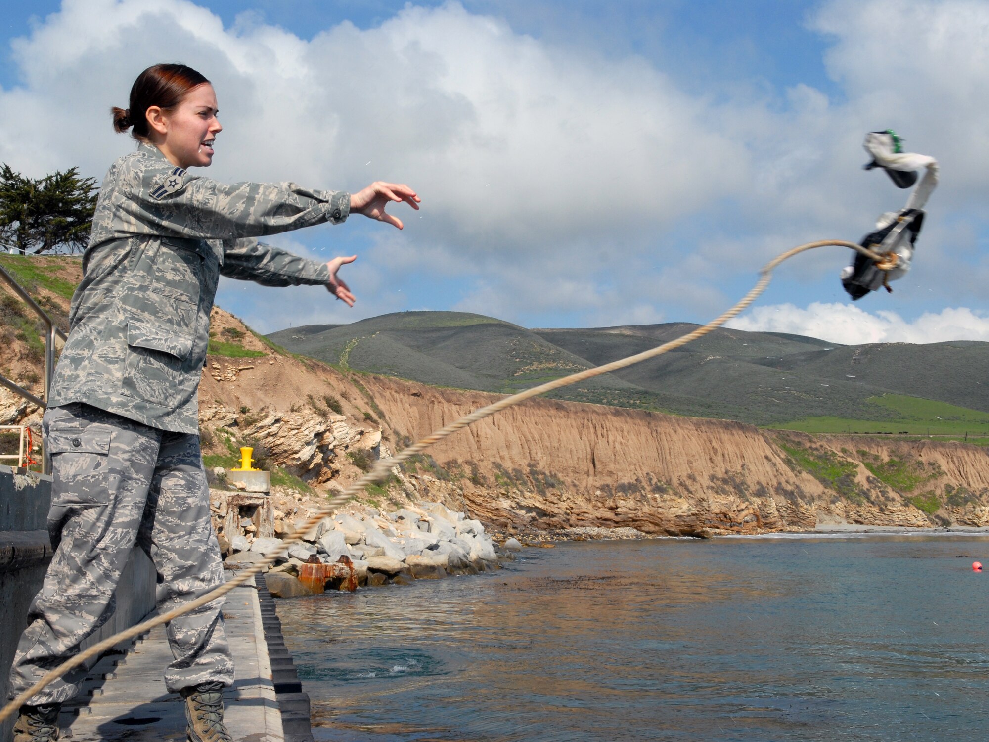 VANDENBERG AIR FORCE BASE, Calif. -- Casting out the water sampling net and canister, Airman 1st Class Megan Necessary of the 30th Medical Operations Squadron Public Health office gathers ocean water for testing near the Boat House here Tuesday, Feb. 2, 2010. Public health personnel ensure the safety of Vandenberg’s beaches by having the water’s phytoplankton tested for toxic chemicals and “red tide.” (U.S. Air Force photo/Airman 1st Class Angelina Drake)