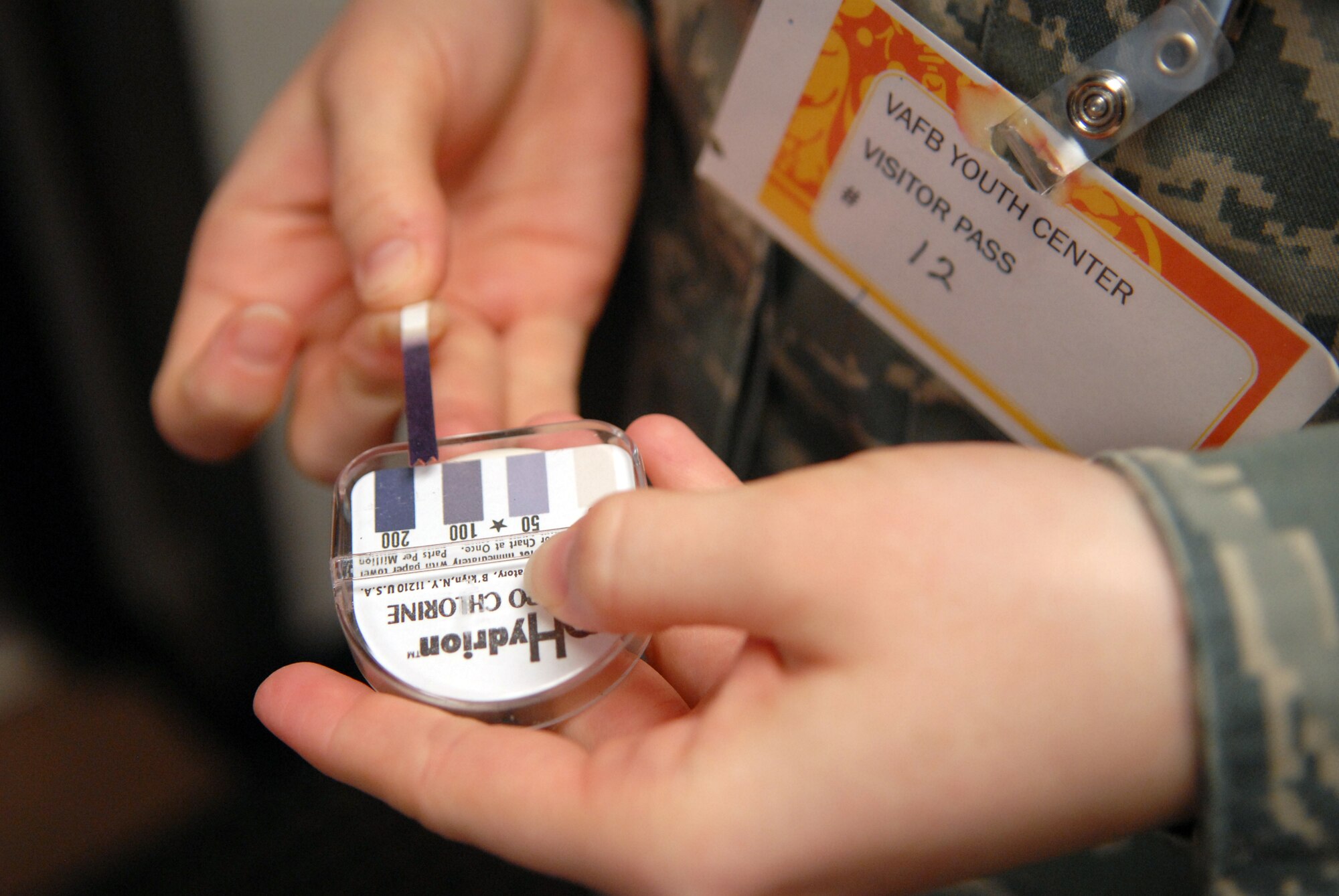 VANDENBERG AIR FORCE BASE, Calif. -- Comparing a color example to a test swatch, Airman 1st Class Brooke Parks of the 30th Medical Operations Squadron Public Health office tests the amount of chlorine in sanitizer water used in the Youth Center kitchen here Tuesday, Feb. 2, 2010. The mandatory parts per million of chlorine is no less than 100 for kitchen use and no less than 200 for bathroom use, which properly ensures the decontamination of surfaces and sanitization. (U.S. Air Force photo/Airman 1st Class Angelina Drake)
