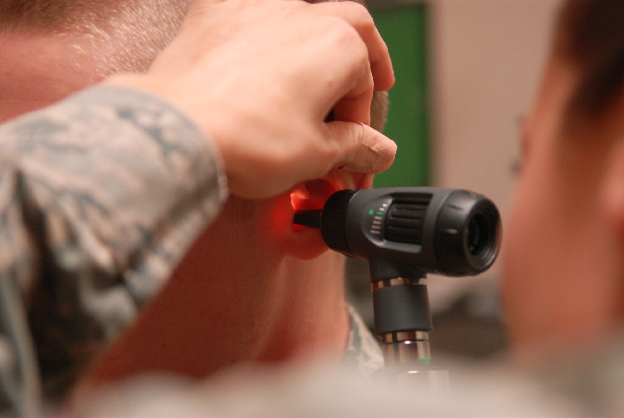 VANDENBERG AIR FORCE BASE, Calif. -- Inspecting the auditory canal, Senior Airman Caitlin Gaudet of the 30th Medical Operations Squadron Public Health office uses the otoscope to search the ear canal of a patient here Tuesday, Feb. 2, 2010. The lighted ear exam is conducted before a hearing exam to ensure no obstructions exist in the auditory canal that would inhibit the listener from passing the exam. (U.S. Air Force photo/Airman 1st Class Angelina Drake)
