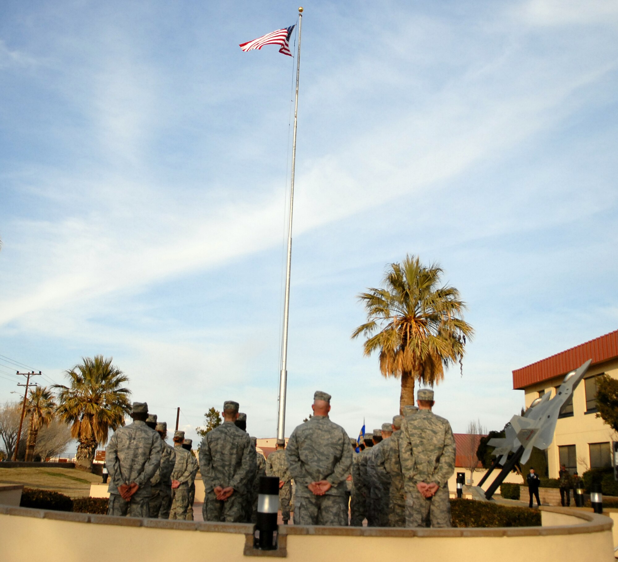 Airmen stand in formation during a retreat ceremony in front of the Air Force Flight Test Center Headquarters Feb. 2. The officiating officer for the ceremony was Col. Paul Hardy, 95th Communications Group commander. A retreat ceremony marks the end of the duty day and honors the American Flag. (Air Force photo/Airman 1st Class William O'Brien)