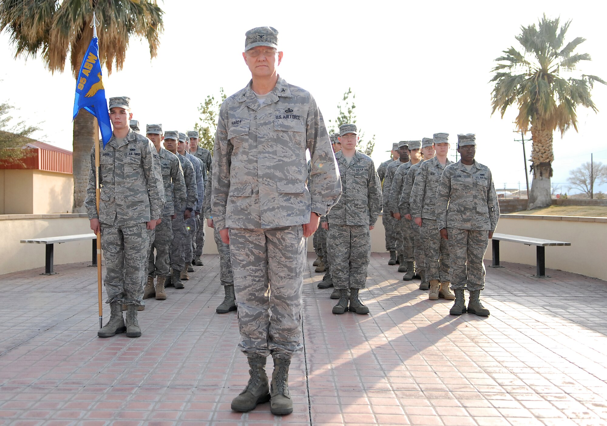Col. Paul Hardy, 95th Communications Group commander, leads a flight of Airmen during a retreat ceremony in front of the Air Force Flight Test Center Headquarters Feb. 2. A retreat ceremony marks the end of the duty day and honors the American Flag. (Air Force photo/Airman 1st Class William O'Brien)