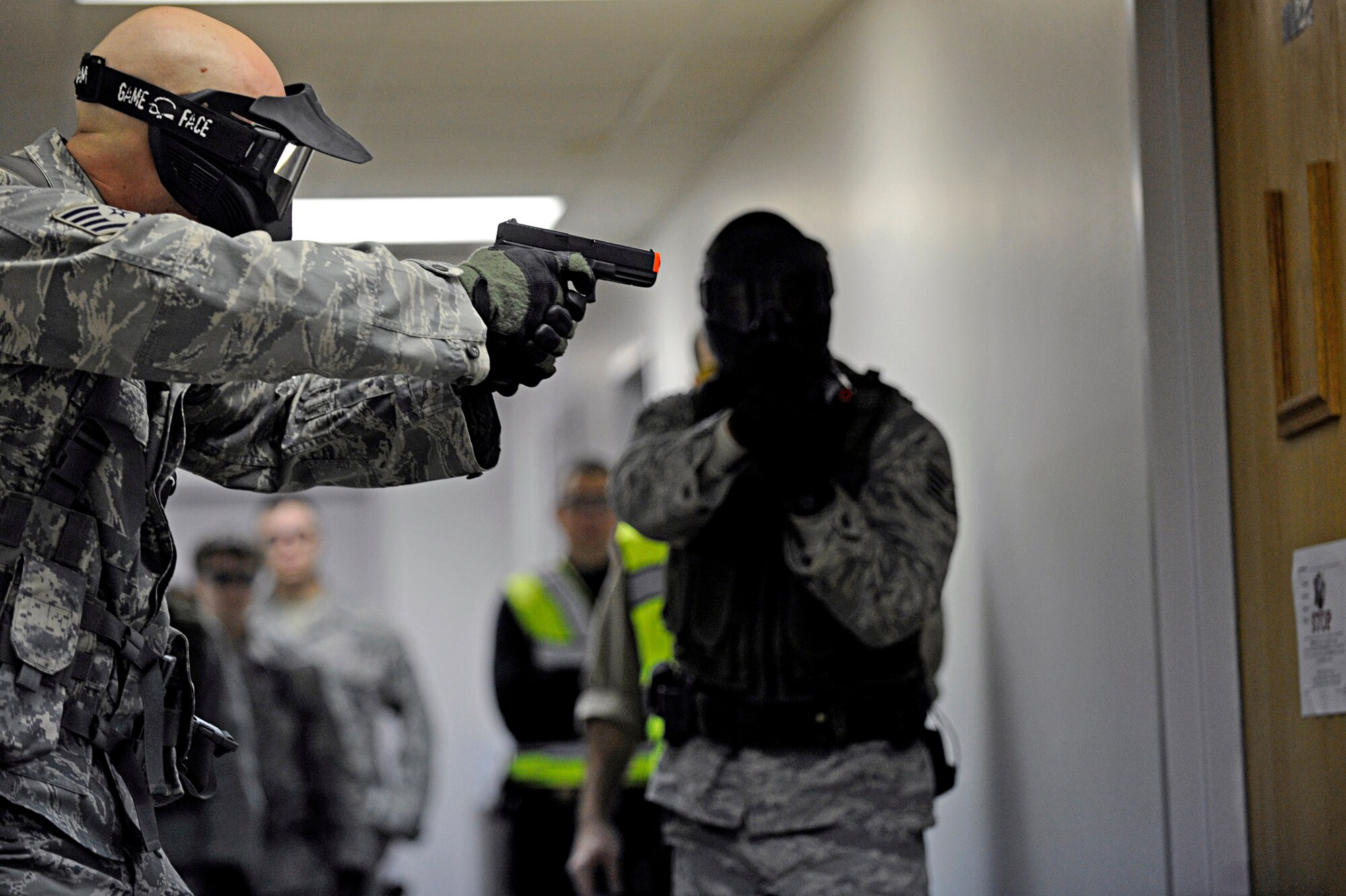 Staff Sgt. Joseph Vawter (left) and Staff Sgt. Alston Alexander clear a room during an armed threat exercise, Jan. 25, 2010, at Ellsworth Air Force Base, S.D. Airmen received specific training from the Pennington County Sheriff's Department special response team to neutralize the threat as quickly as possible. Sergeants Vawter and Alexander are 28th Security Forces Squadron team members. (U.S. Air Force photo/Airman 1st Class Matthew Flynn)