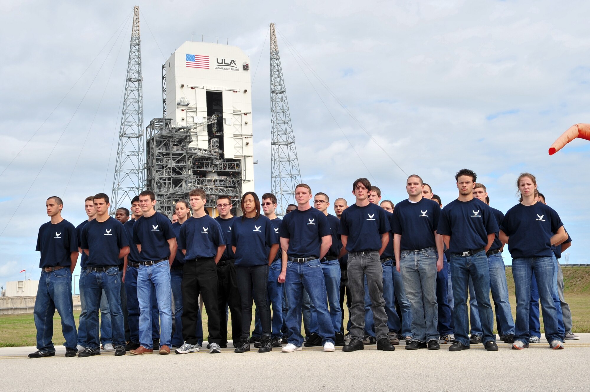 Air Force recruits stand in front of a Delta IV booster being readied for launch Feb. 4 at Cape Canaveral Air Force Station. Moments before the recruits had been inducted into the Delayed Entry Program by 45th Space Wing Commander Brig. Gen. Edward L. Bolton Jr. (U.S. Air Force photo/Jennifer Macklin)