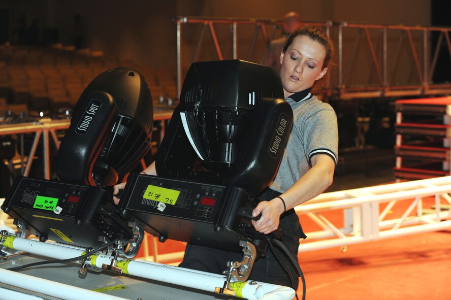 SUMTER, S.C. -- Airman 1st Class Sheila Smith, a performer with Tops In Blue,  unloads stage equipment before performing for the Sumter community at Patriot Hall Feb. 3. Tops in Blue, an ensemble made up of the most-talented Airmen in the force, entertains military and civilian audiences around the globe with music. Their tour encompasses more than 120 shows worldwide and includes numerous shows for deployed Airmen in the Southwest Asia area of operations. (U.S. Air Force photo/Tech. Sgt. Louis Rivers)