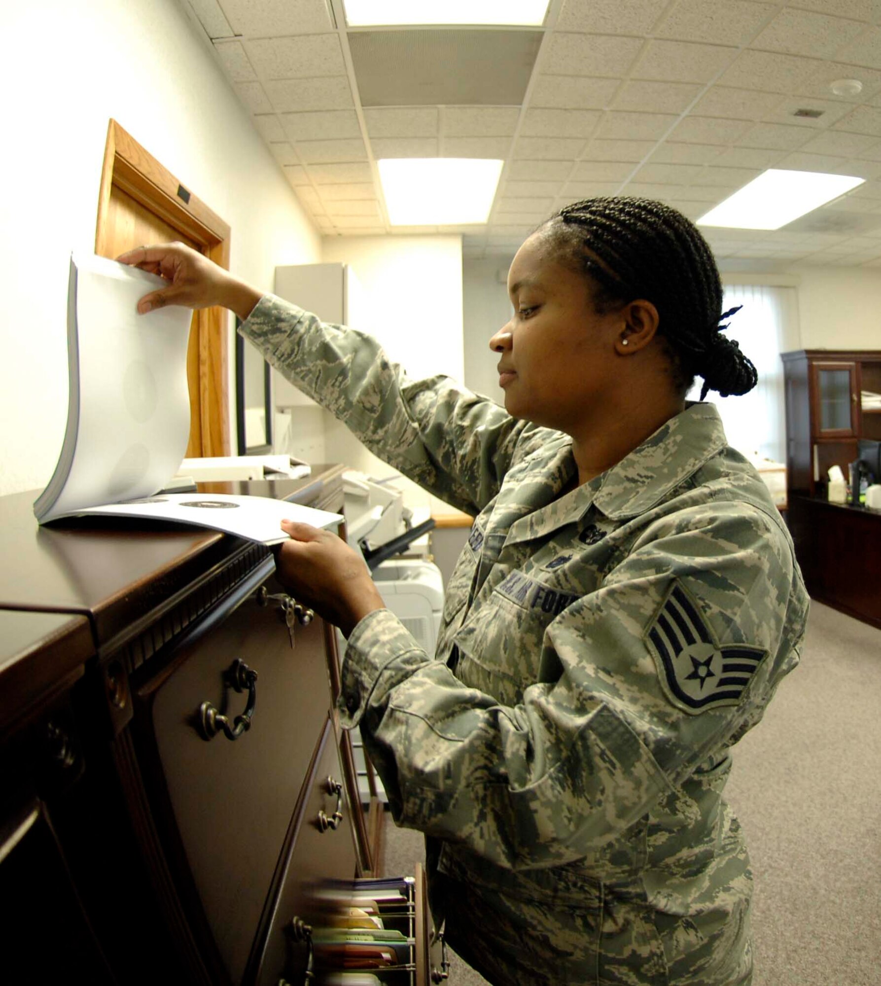Staff Sgt. Lashawn Reed, NCOIC of adverse actions from the 22nd Legal Office, consults past Article 15 cases. In addition to assisting with Article 15s, the Eureka, N.C., native helps units at McConnell facilitate cases for demotions, administrative actions and discharges of Airmen. (U.S. Air Force photo/Senior Airman Abigail Klein)

