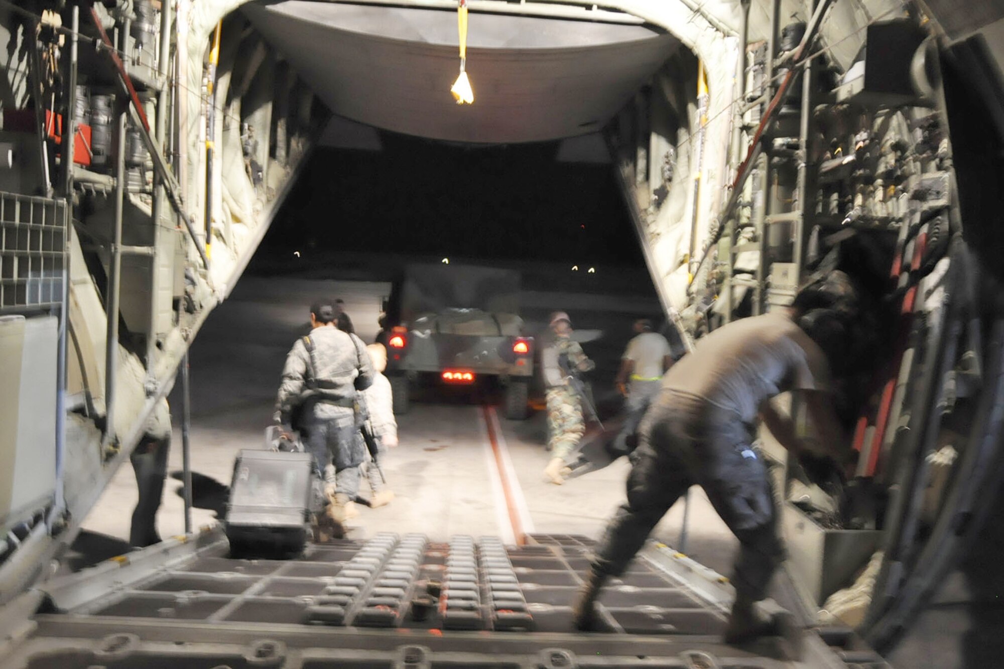 The last member of a group of 19 U.S. military medical people leaves a C-130H Hercules at Toussaint L’Ouverture International Airport in Port-au-Prince, Haiti, Jan. 18.  The medical team U.S. Army and Air Force service members from Soto Cano Air Base, Honduras, was flown there by the Air Force Reserve Command’s 910th Airlift Wing, Youngstown Air Reserve Station, Ohio.  Colonel Williams and Captain Carter deployed to Haiti from Honduras.  (U.S. Air Force photo by Bob Barko Jr.)
