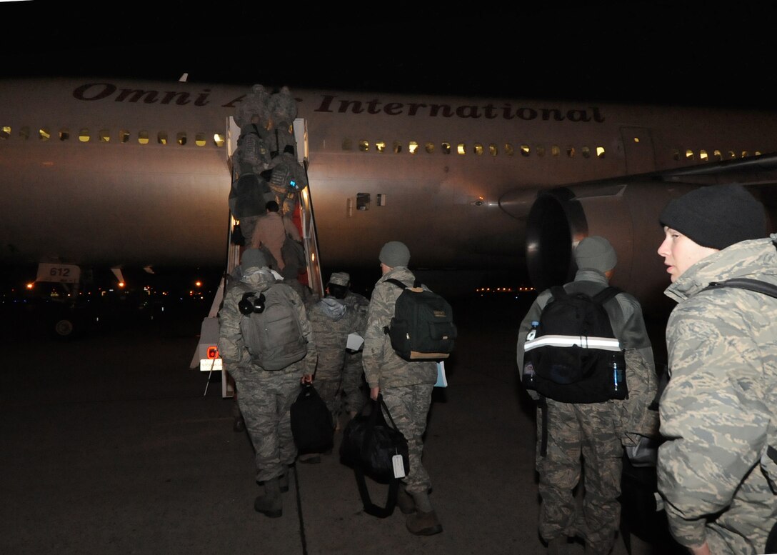 Deploying Airmen assigned to the 113th Wing Maintenance Squadron at Joint Base Andrews, Md.,board a commercial DC-10 aircraft en route to Joint Base Balad in Northern Iraq Jan. 29, 2010. The members are slated to deploy in support of Operation ENDURING FREEDOM. (US Air Force photo/Bobby Jones)