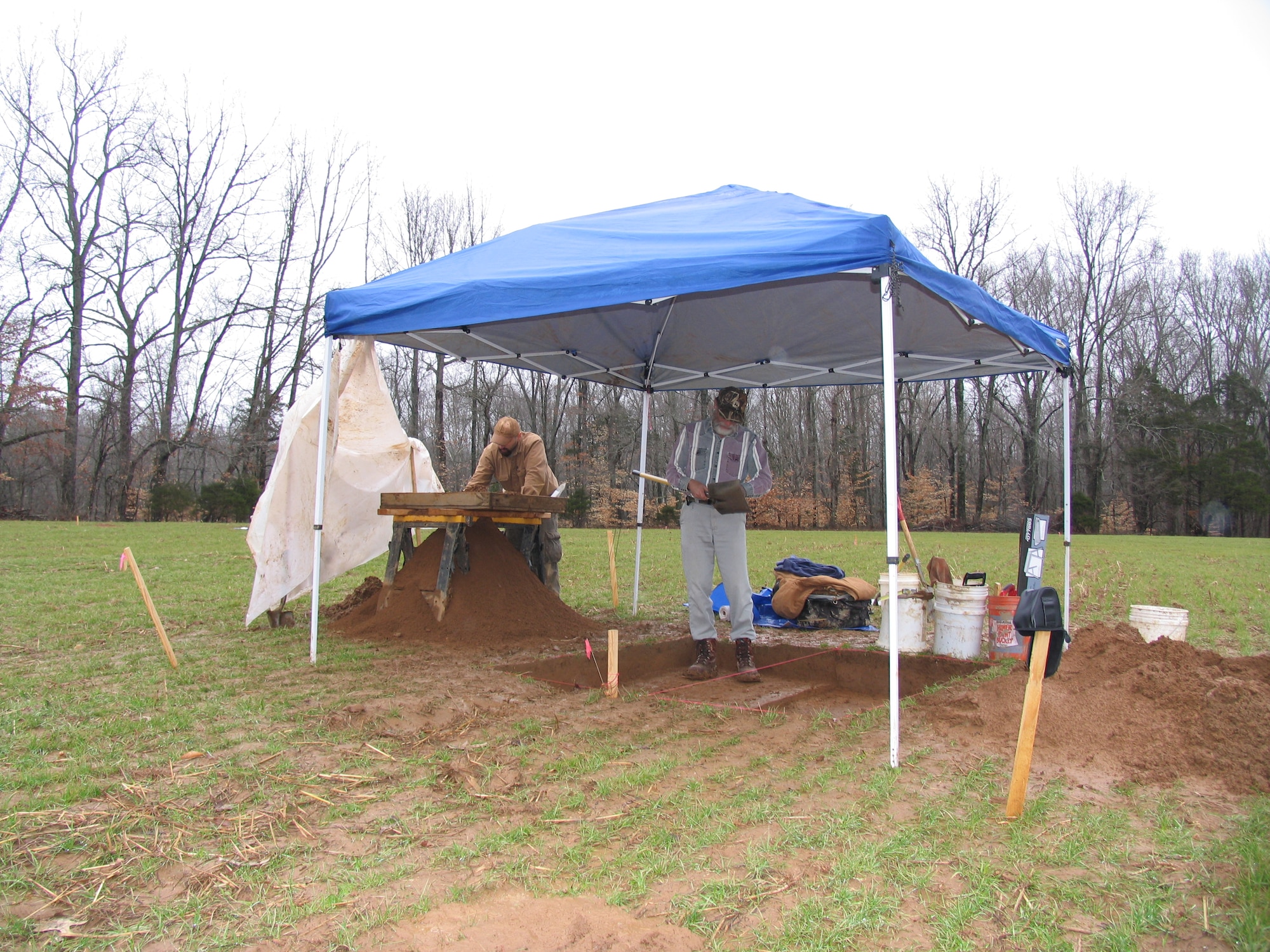 Two AMEC Earth and Environmental Inc., workers carefully dig at an anomaly detected earlier by gradiometer mapping at one of four prehistoric sites under investigation for Native American artifacts. (Photo by Shawn Chapman)