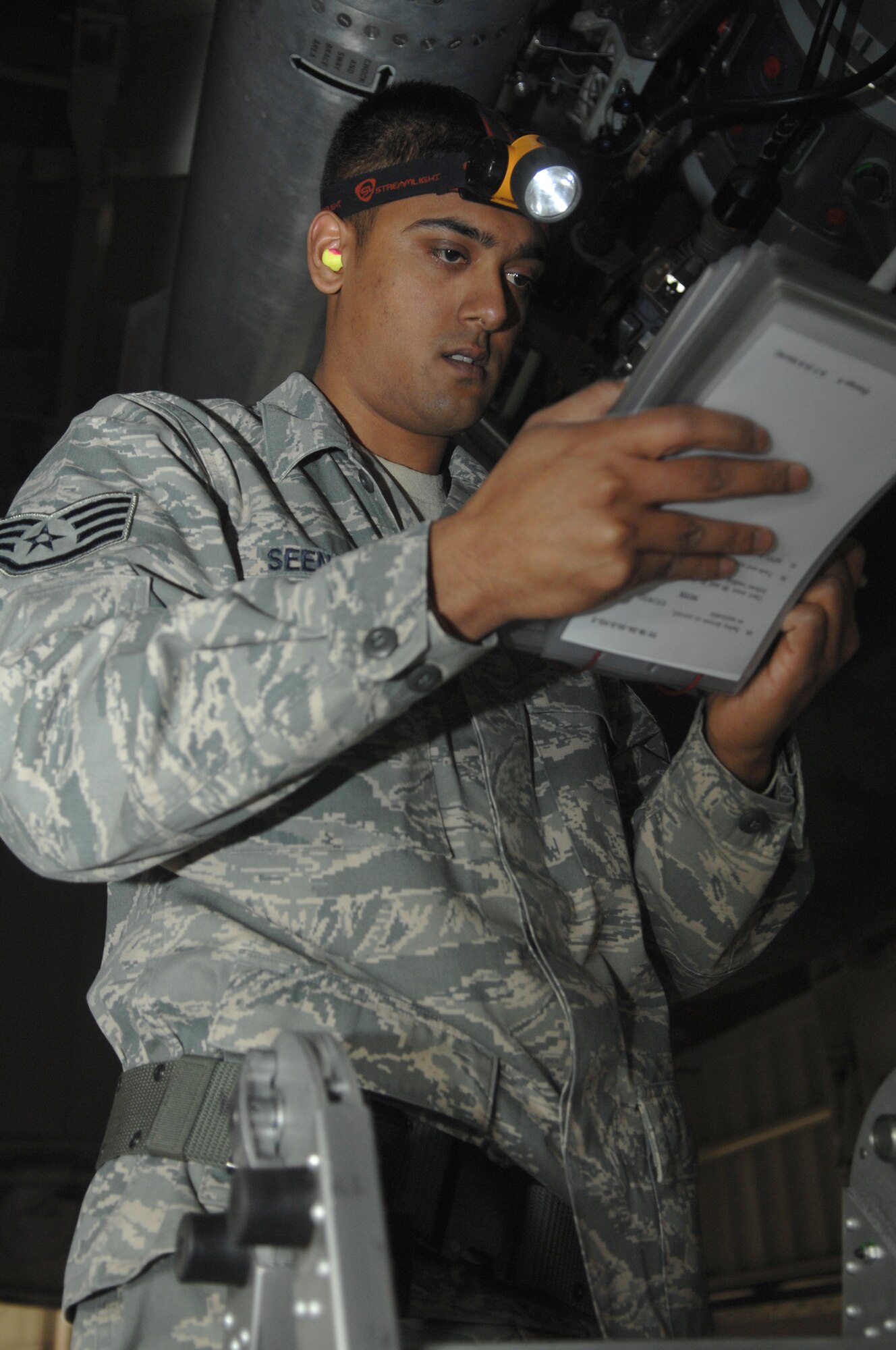 WHITEMAN AIR FORCE BASE, Mo., - Staff Sgt.  David Seenauth, 509th Bomb Wing Aircraft Maintenance Squadron member, uses a weapons loading checklist during the Load Crew of the Year Competition Feb. 3, 2010. The winners will be announced at the Maintenance Professional of the Year banquet in March.  (U.S. Air Force photo/Senior Airman Jessica Mae Snow) (Released)