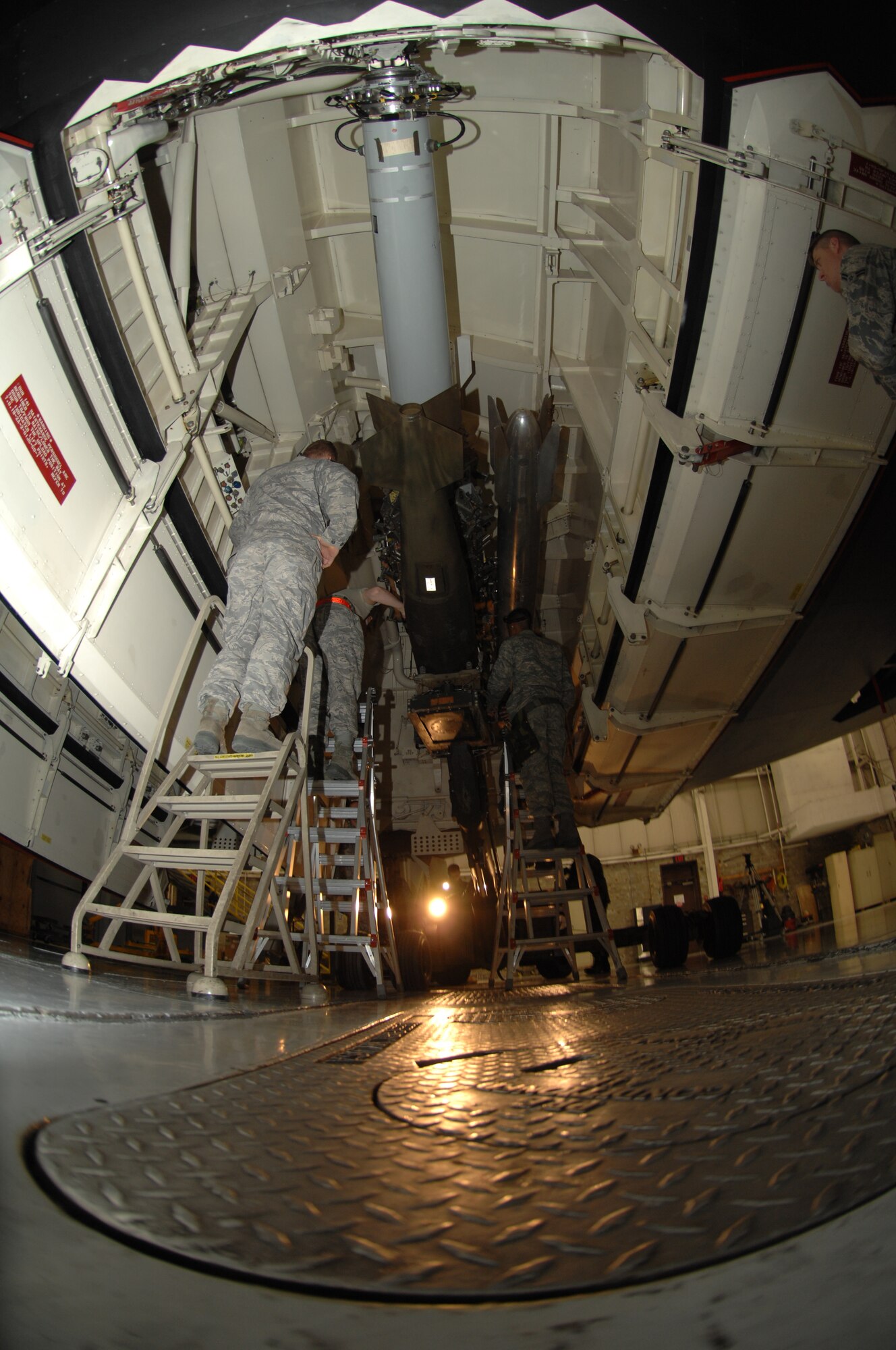 WHITEMAN AIR FORCE BASE, Mo., - A four-man crew lead by Weapons Load Team Chief Staff Sgt.  David Seethnauth, 509th Bomb Wing Aircraft Maintenance Squadron, performs a weapons upload during during the Load Crew of the Year Competition Feb. 3, 2010. The winners will be announced at the Maintenance Professional of the Year banquet in March.  (U.S. Air Force photo/Senior Airman Jessica Mae Snow) (Released)