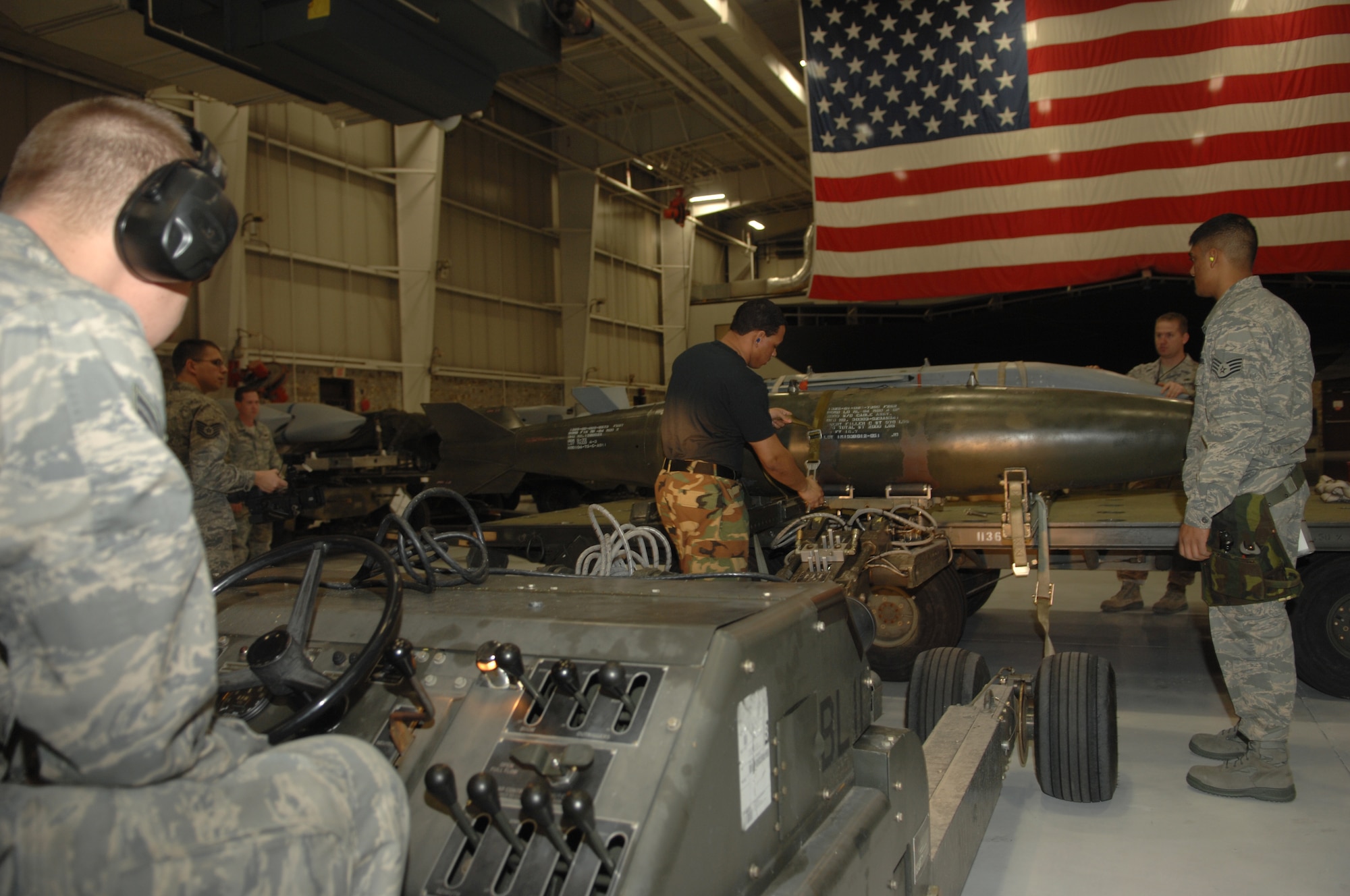WHITEMAN AIR FORCE BASE, Mo., - Senior Airman Christopher Puzan, 509th Bomb Wing Aircraft Maintenance Squadron, operates a jammer to transfer a simulated MK-84 training bomb, to the B-2 weapons load trainer, while Senior Airman Michael Tomaski secures the weapon with a load binder during the Load Crew of the Year Competition Feb. 3, 2010. The load crew of the year will be announced at the Maintenance Professional of the Year banquet in March.  (U.S. Air Force photo/Senior Airman Jessica Mae Snow) (Released)