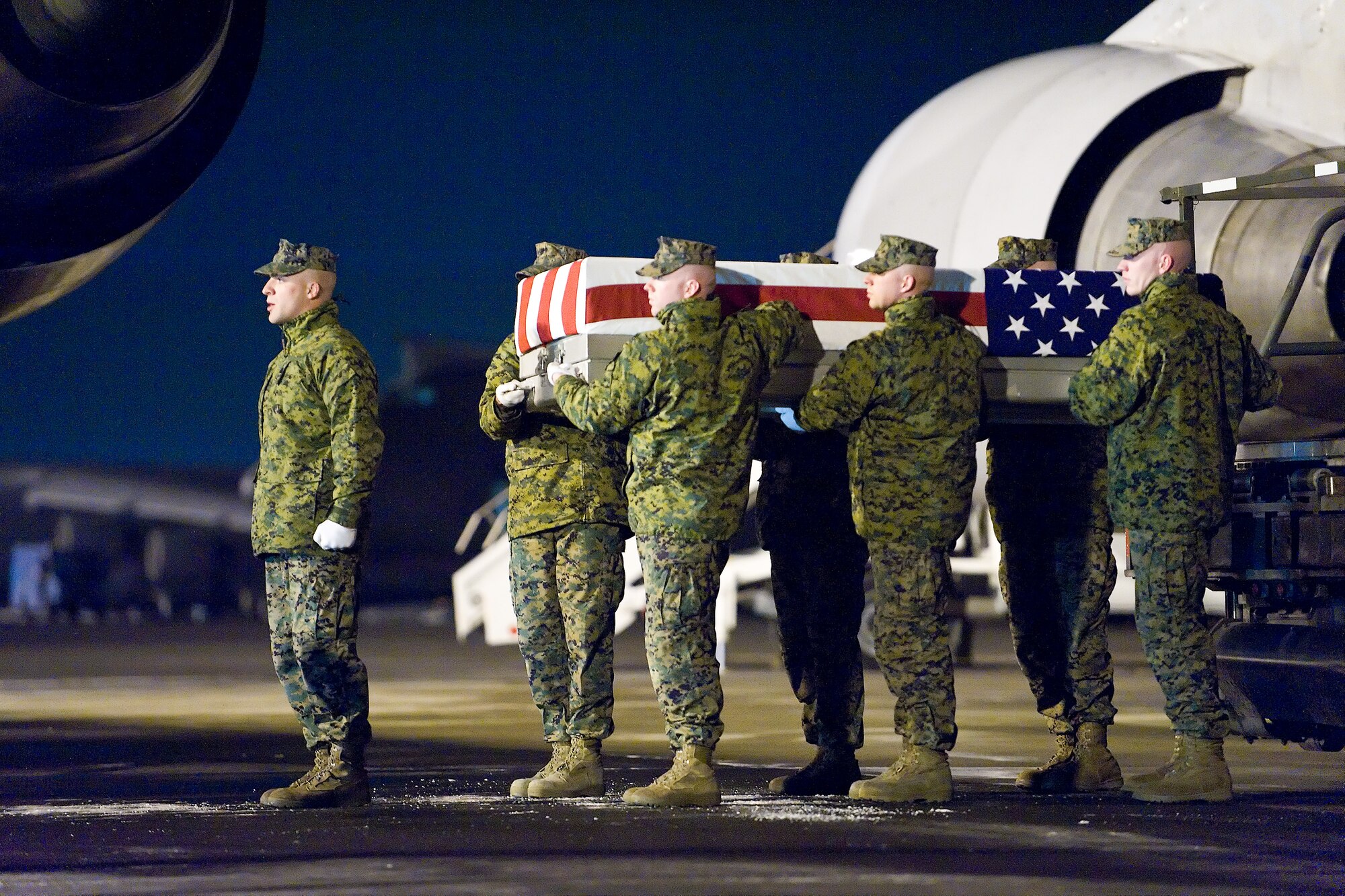 A U.S. Marine Corps team transfers the remains of Marine Corps Lance Cpl. Michael L. Freeman Jr., of Fayetteville, Pa., at Dover Air Force Base, Del., February 2. Lance Cpl. Freeman was assigned to 2nd Battalion, 2nd Marine Regiment, 2nd Marine Division, II Marine Expeditionary Force, Camp Lejeune, N.C. (U.S. Air Force photo/Roland Balik)
