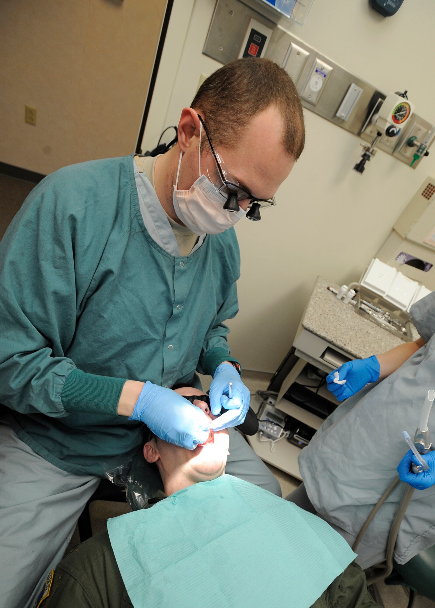 ELMENDORF AIR FORCE BASE, Alaska -- Capt. Anthony Mecham, 3rd Dental Squadron, applies a cap to a patients tooth during an examination Feb. 3. Captain Mecham was completing a dental procedure where a patient needed a cap placed over a rotten tooth. (Air Force photo/ Senior Airman Matt Coleman-Foster)