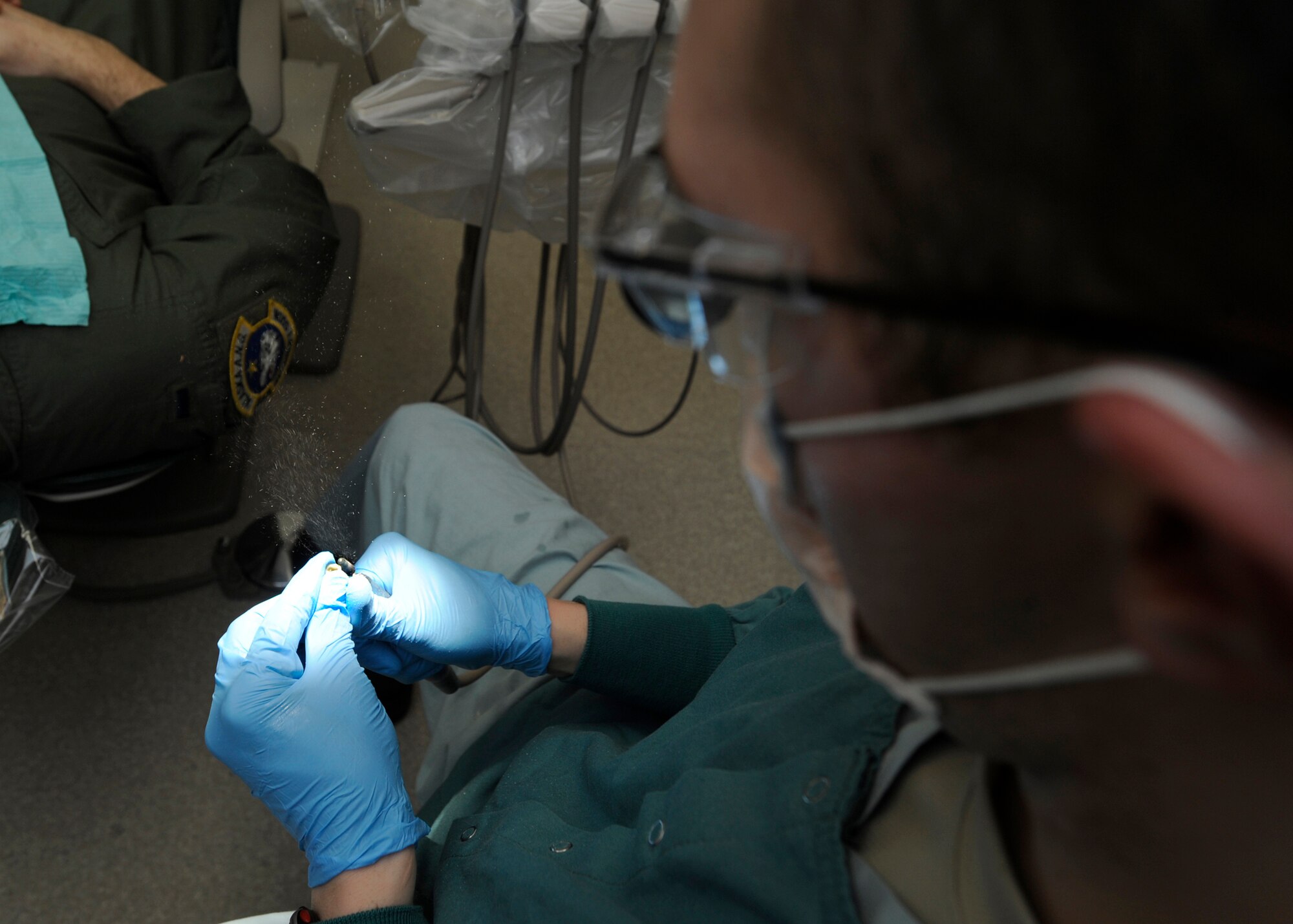 ELMENDORF AIR FORCE BASE, Alaska--Capt. Anthony Mecham, 3rd Dental Squadron, modifies a tooth cap before applying it to a patient Feb. 3. Captain Mecham was completing a dental procedure where a patient needed a cap placed over a rotten tooth. (Air Force photo/ Senior Airman Matt Coleman-Foster)