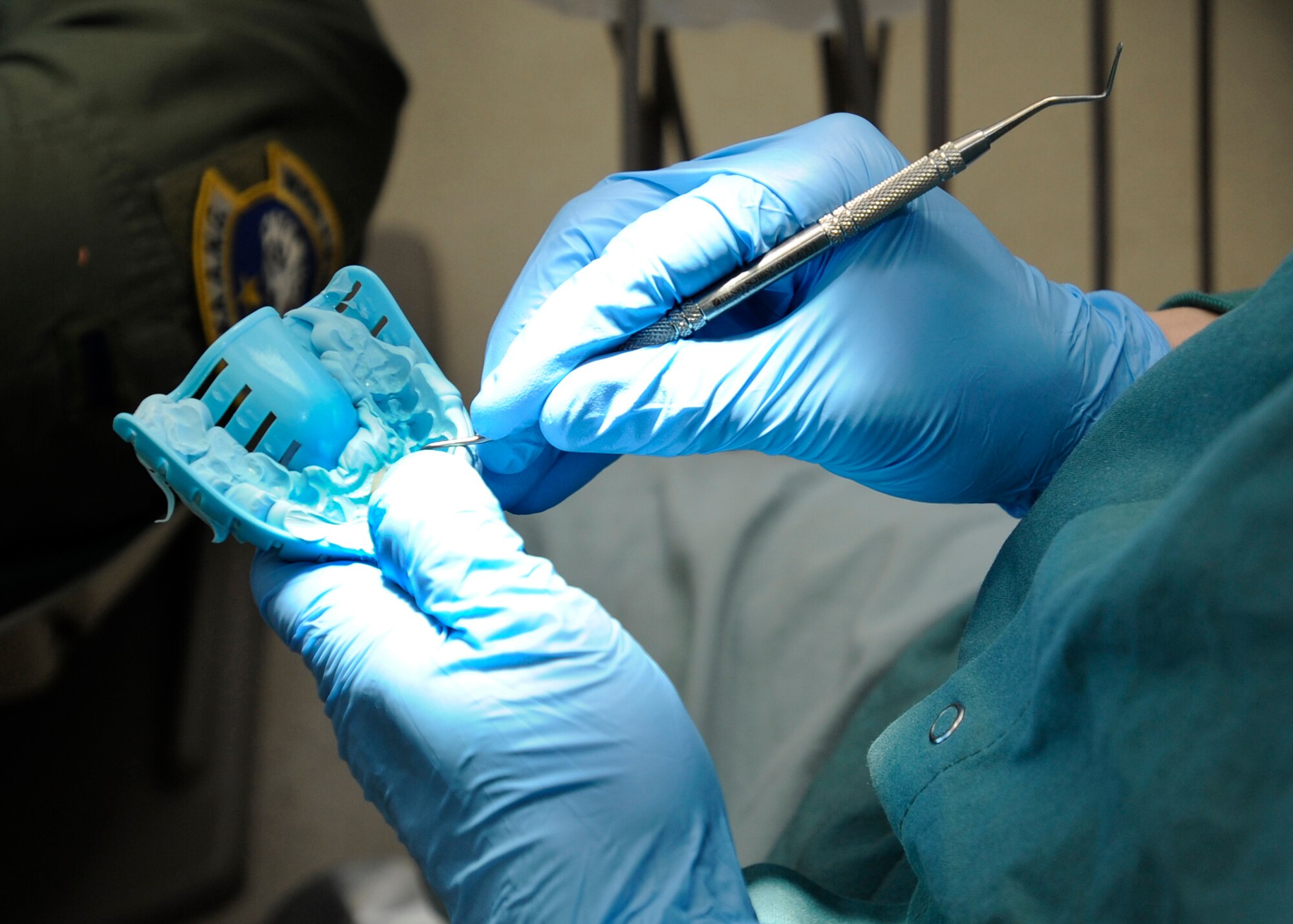 ELMENDORF AIR FORCE BASE, Alaska -- Capt. Anthony Mecham, 3rd Dental Squadron, examines a tooth cap before modifying it Feb. 3. Captain Mecham was completing a dental procedure where a patient needed a cap placed over a rotten tooth. (Air Force photo/ Senior Airman Matt Coleman-Foster)
