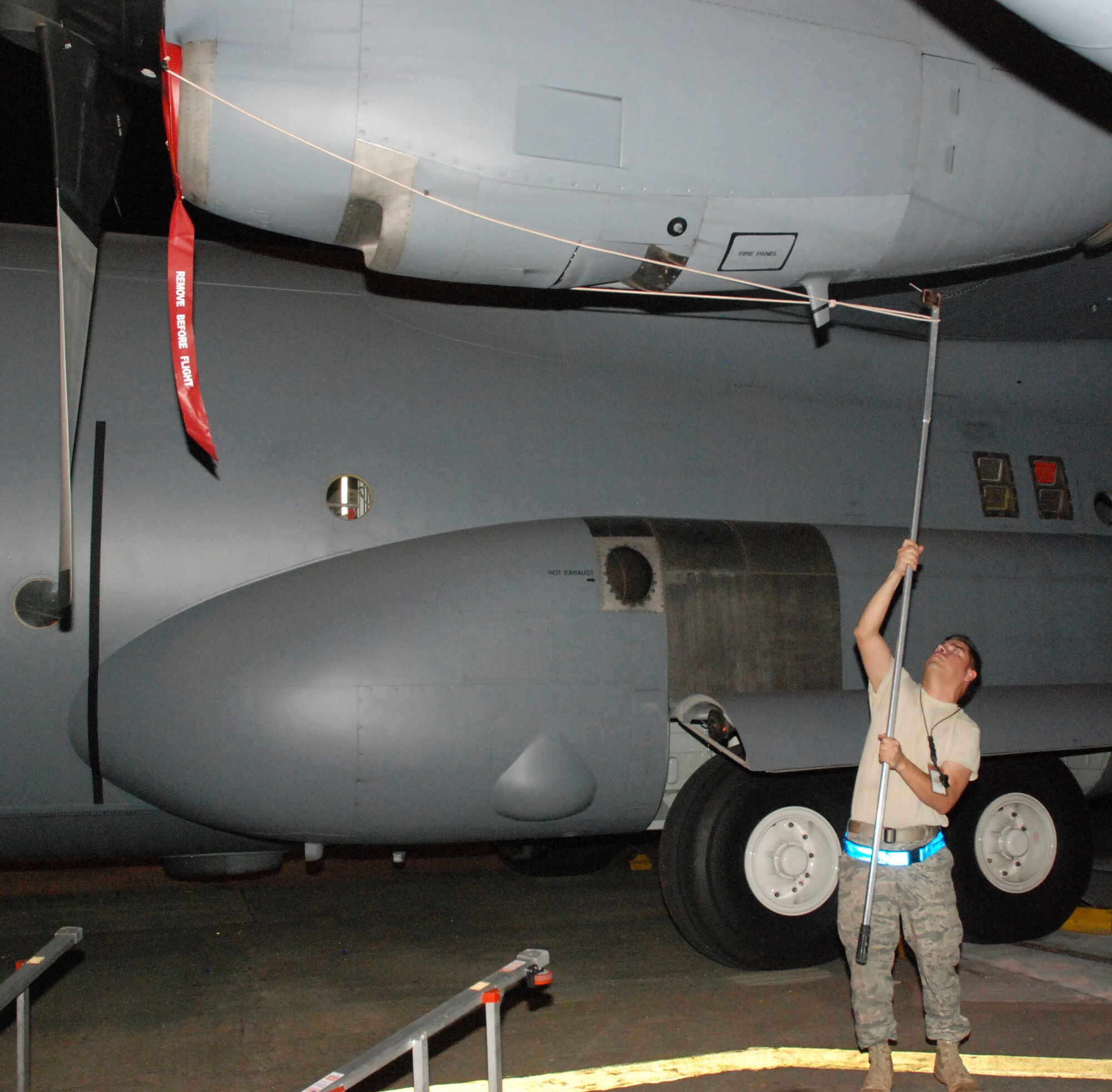 Tech. Sgt. Steve Cisneros inserts a protective plug for a C-130 Hercules engine air intake chamber Jan. 27, 2010, at Muniz Air Base, Puerto Rico. Sergeant Cisneros is a 35th Expeditionary Airlift Squadron crew chief from the 302nd Airlift Wing, Air Force Base, Colo. (U.S. Air Force photo/Master Sgt. Stan Coleman)