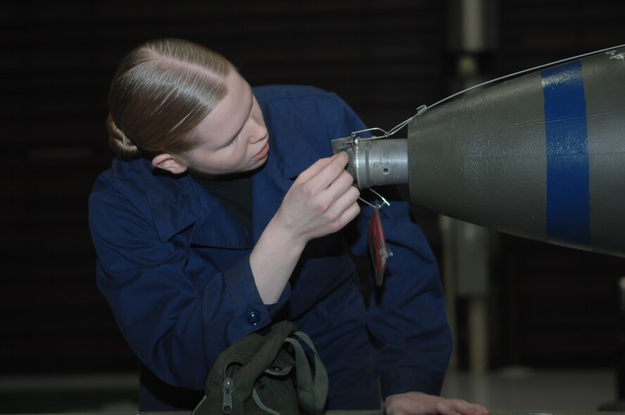 WHITEMAN AIR FORCE BASE, Mo., - Senior Airman Dorinda Becker, 509th Bomb Wing Aircraft Maintenance Squadron, inspects the nose fuse on a simulated MK-84 training bomb for serviceability during the Load Crew of the Year Competition Feb. 3, 2010. The load crew of the year will be announced at the Maintenance Professional of the Year banquet in March.  (U.S. Air Force photo/Senior Airman Jessica Mae Snow) (Released)
