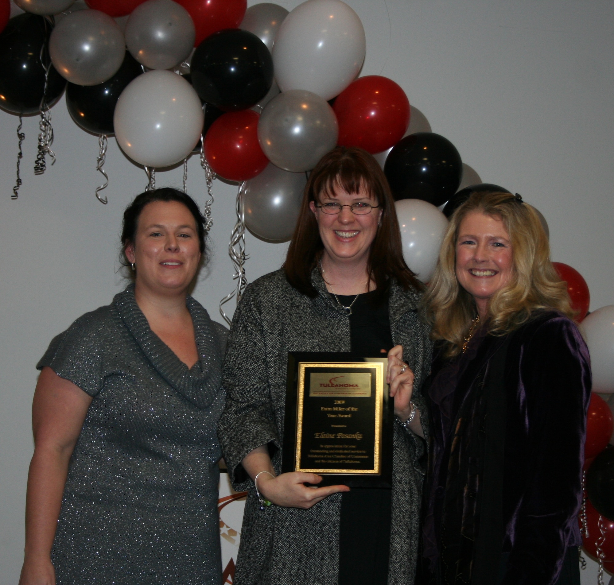 Left to far right, Karla Smith, 2009 Tullahoma Area Chamber of Commerce (TACC) president and Diane Bryant Executive Director of the Tullahoma Chamber, present Lt. Col. Elaine Posanka, center, with the 2009 TACC Extra Miler of the Year Award at Tullahoma’s Business Development Center Jan. 23. (Photo provided)