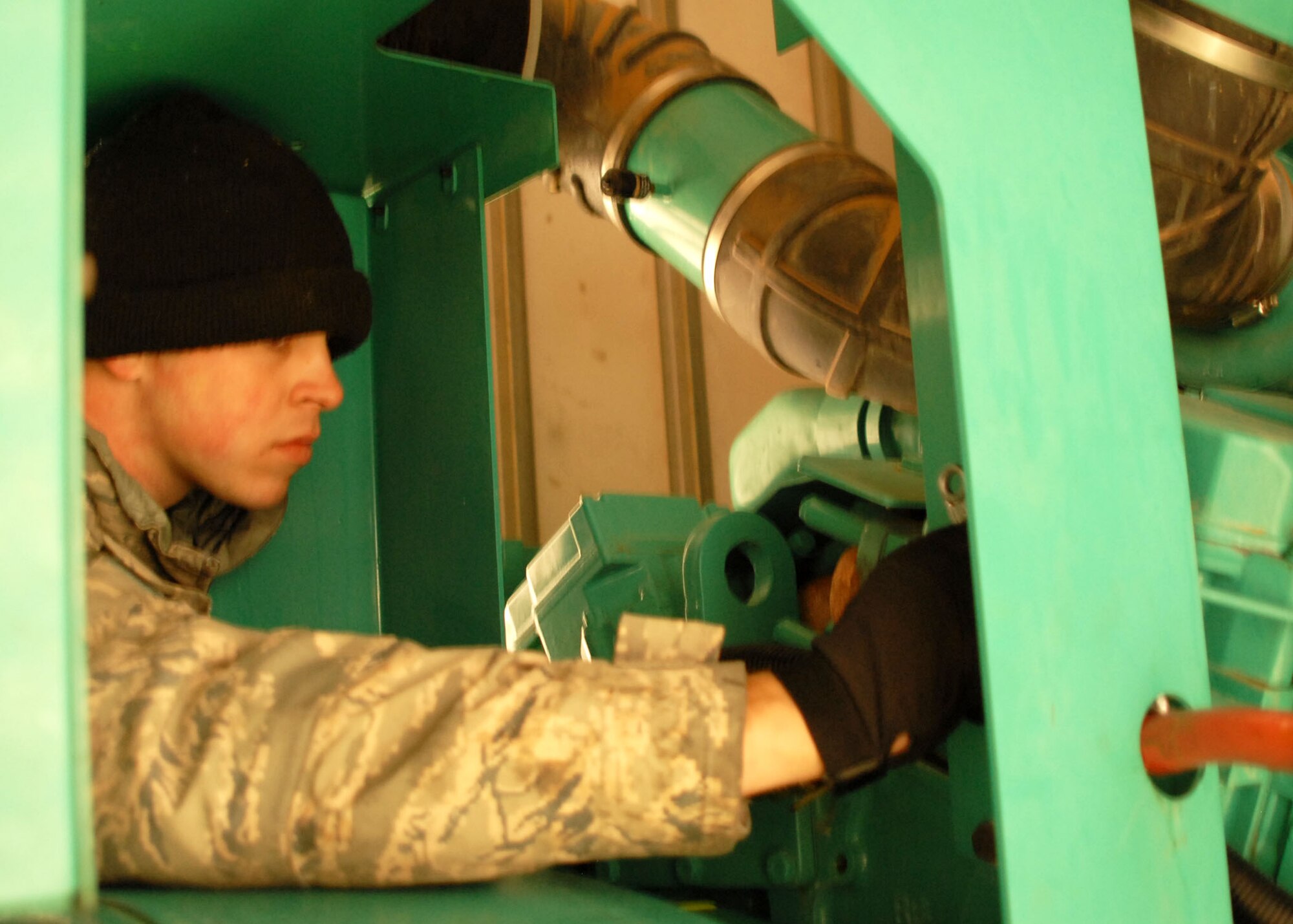ALTUS AIR FORCE BASE, Okla. -- Senior Airman Jared Mahaffey, from the 802nd Civil Engineering Squadron at Lackland AFB, Texas, repairs a generator supporting building 361 Feb 3. Mahaffey is providing the base essential support in order to bring the base back to normal. The severe ice storm damaged many power lines on base and the main base area has been without power since Jan. 28.  (U.S. Air Force photo/Airman 1st Class Christopher A. Arnold)